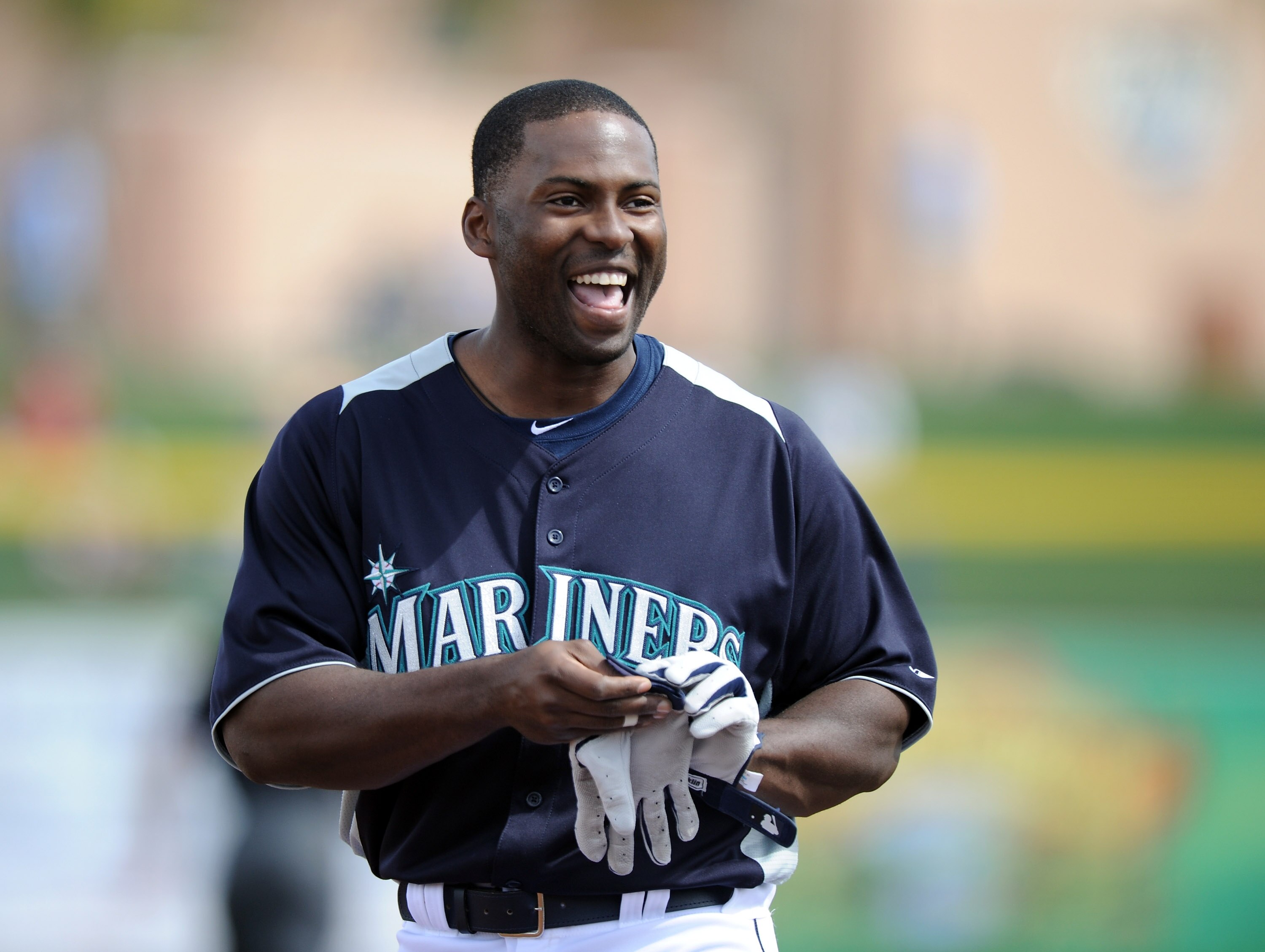 PEORIA, AZ - MARCH 01:  Milton Bradley #15 of the Seattle Mariners smiles as he leaves the field against the Texas Rangers during spring training at Peoria Stadium on March 1, 2011 in Peoria, Arizona.  (Photo by Harry How/Getty Images)