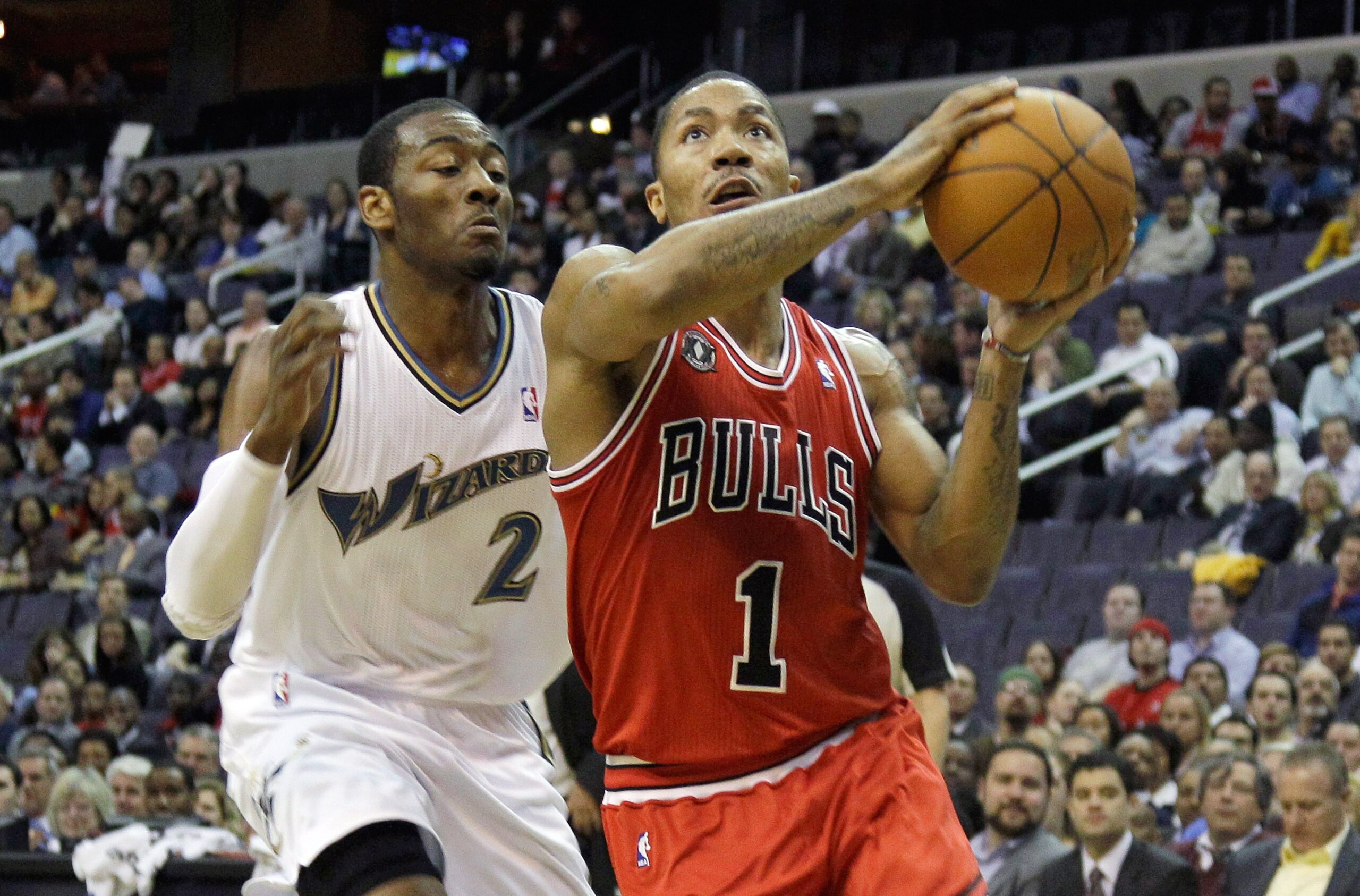 WASHINGTON, DC - FEBRUARY 28: Derrick Rose #1 of the Chicago Bulls drives to the basket while being guarded by John Wall #2 of the Washington Wizardsat the Verizon Center in Washington on February 28, 2011 in Washington, DC. NOTE TO USER: User expressly a