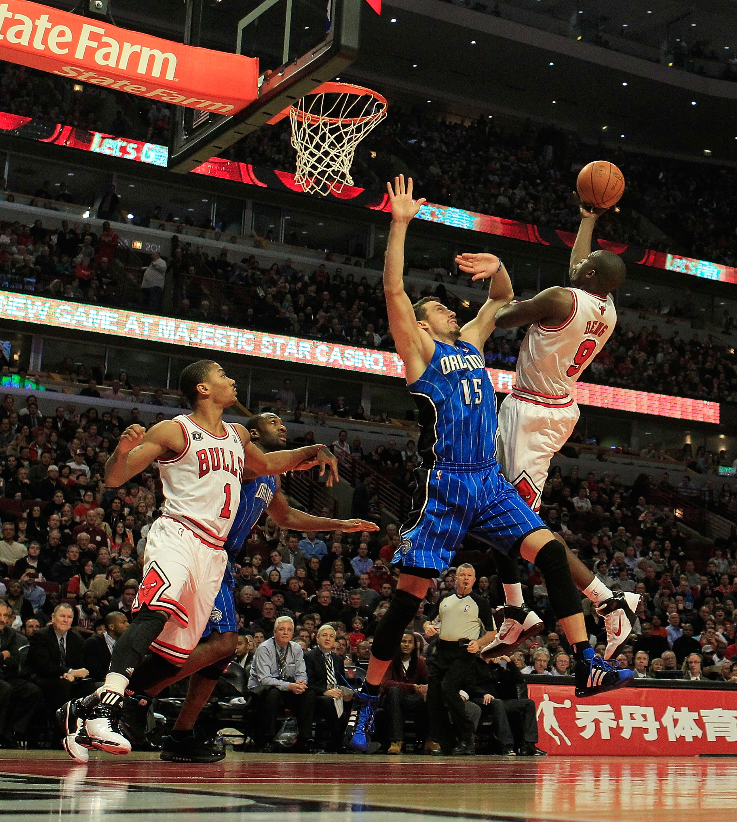 CHICAGO, IL - JANUARY 28: Loul Deng #9 of the Chicago Bulls puts up a shot against Hedo Turkoglu #15 of the Orlando Magic as teammate Derrick Rose #1 watches at the United Center on January 28, 2011 in Chicago, Illinois. The Bulls defeated the Magic 99-90