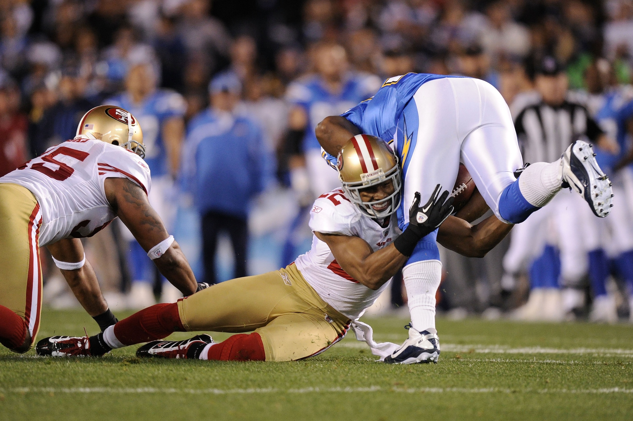 SAN DIEGO, CA - DECEMBER 16:  Running back Mike Tolbert #35 of the San Diego Chargers is tackled by cornerback Nate Clements #22 of the San Francisco 49ers in the first quarter at Qualcomm Stadium on December 16, 2010 in San Diego, California.  (Photo by