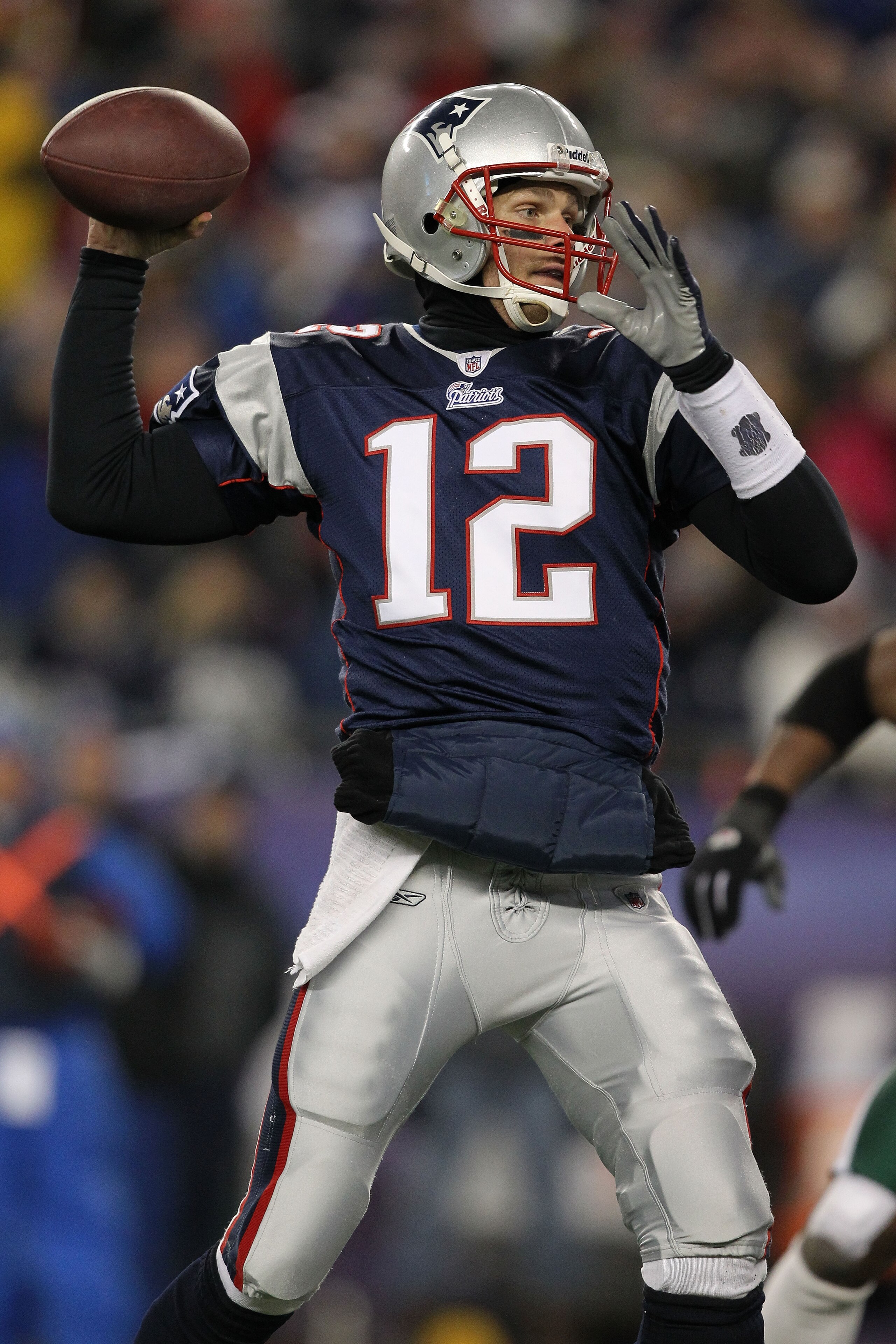 FOXBORO, MA - JANUARY 16:  Quarterback Tom Brady #12 of the New England Patriots throws a pass during their 2011 AFC divisional playoff game against the New York Jets at Gillette Stadium on January 16, 2011 in Foxboro, Massachusetts.  (Photo by Al Bello/G