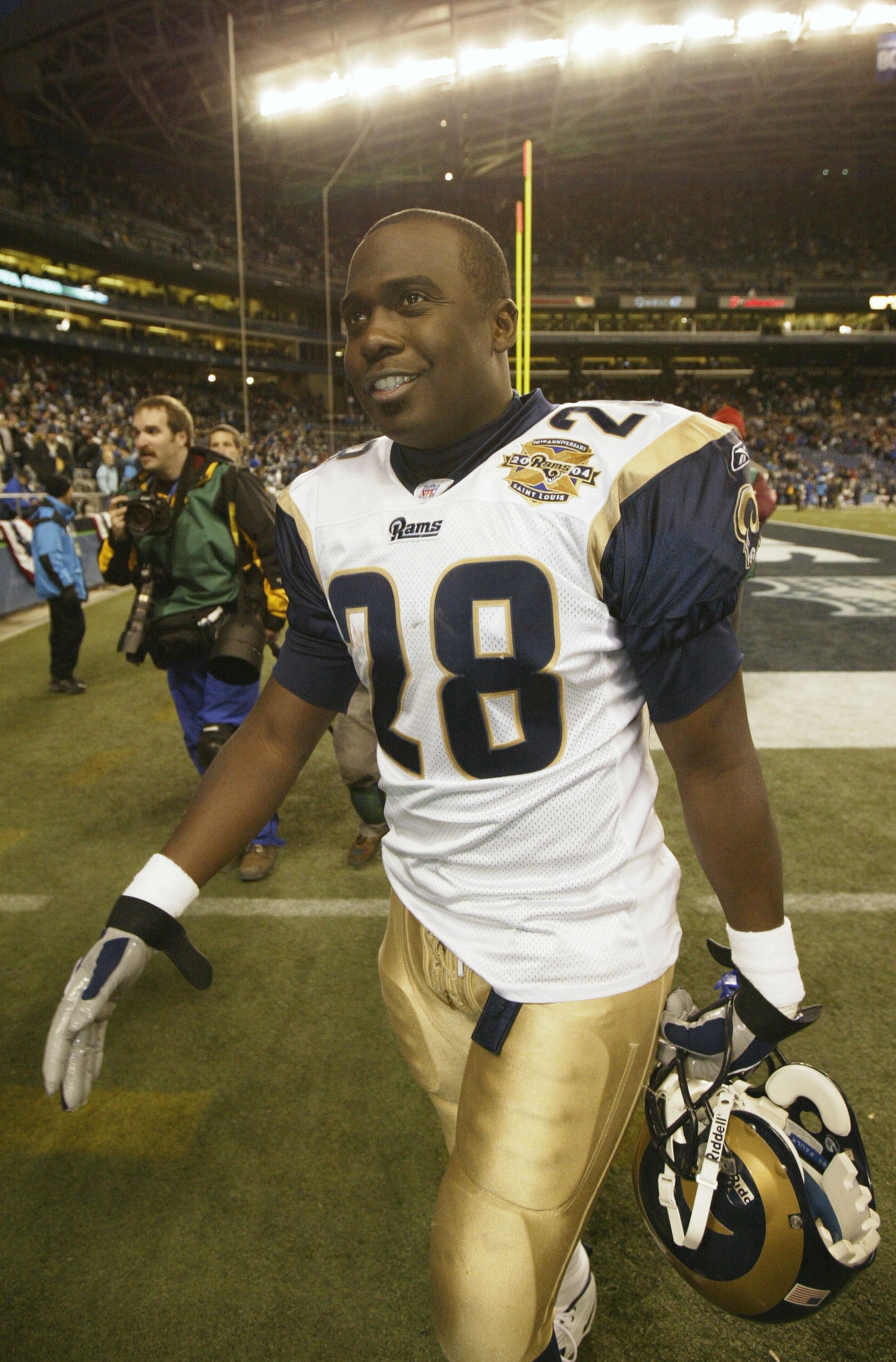 SEATTLE - JANUARY 8:  Running back Marshall Faulk #28 of the St. Louis Rams walks off the field after his team defeated the Seattle Seahawks in the NFC wild-card game at Qwest Field on January 8, 2005 in Seattle, Washington. The Rams defeated the Seahawks