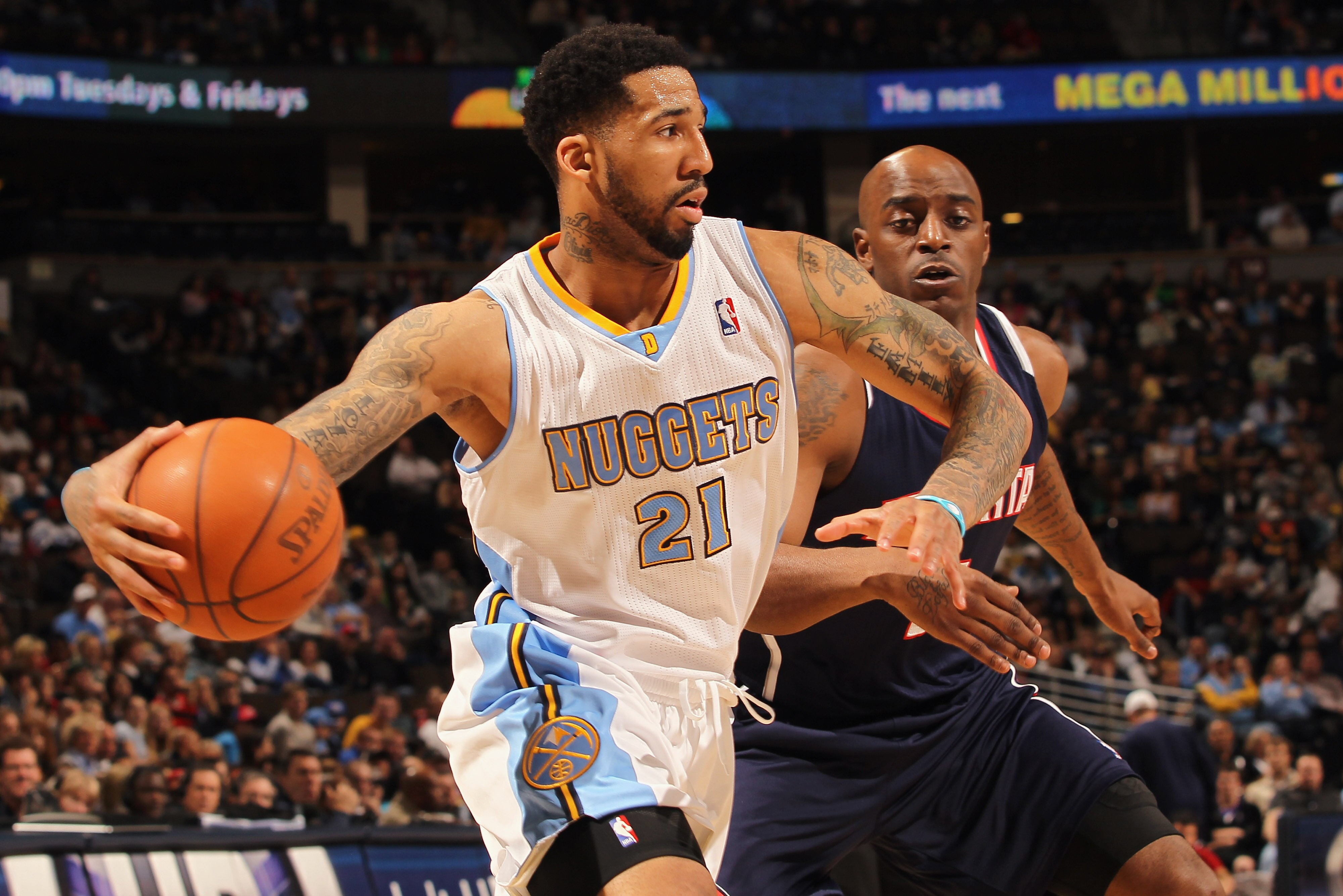 DENVER, CO - FEBRUARY 28:  Wilson Chandler #21 of the Denver Nuggets drives the ball against Damien Wilkens #3 of the Atlanta Hawks during NBA action at the Pepsi Center on February 28, 2011 in Denver, Colorado. NOTE TO USER: User expressly acknowledges a