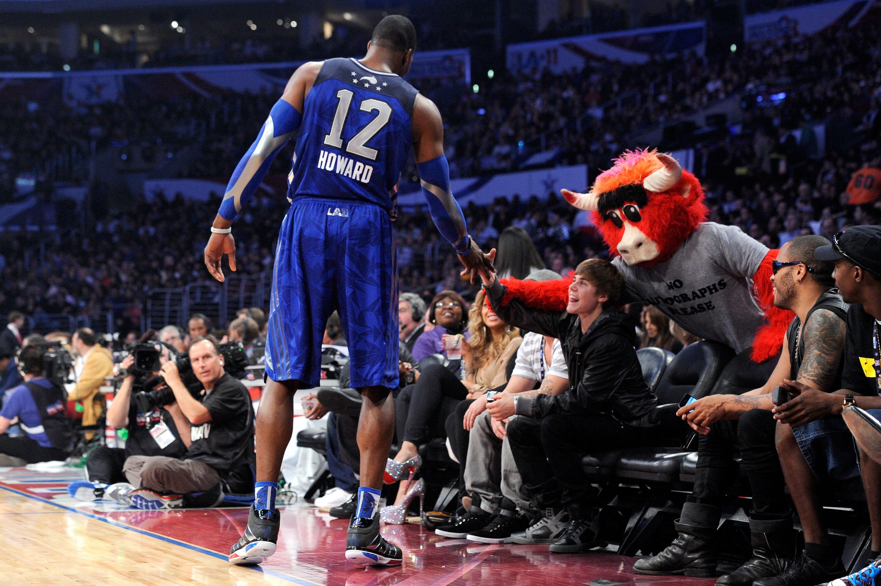 LOS ANGELES, CA - FEBRUARY 20:  (L-R) Dwight Howard #12 of the Orlando Magic and the Eastern Conference, singer Justin Bieber, and Chicago Bulls mascot 'Benny the Bull' courtside during the 2011 NBA All-Star game at Staples Center on February 20, 2011 in 