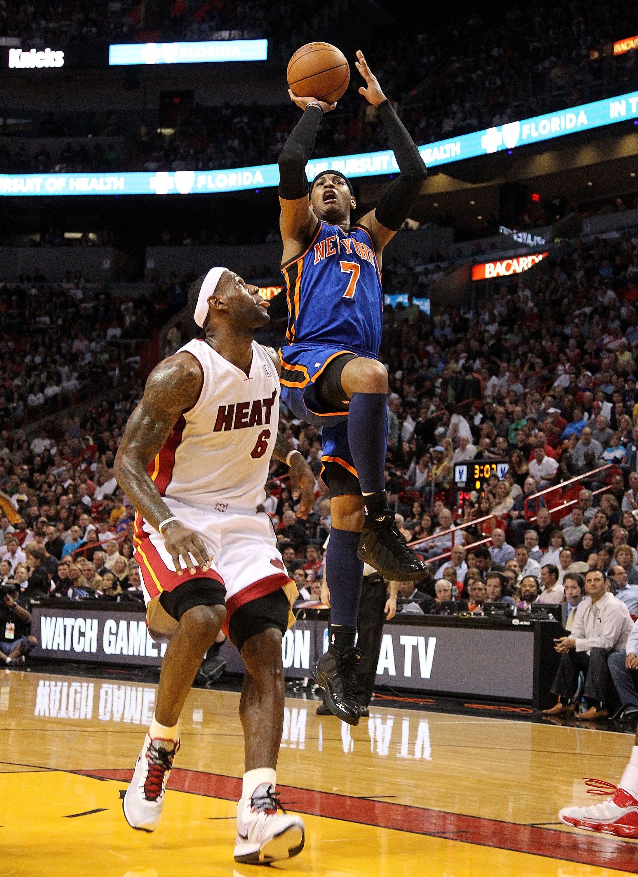 MIAMI, FL - FEBRUARY 27: Carmelo Anthony #7 of the New York Knicks shoots around LeBron James #6 of the Miami Heat during a game at American Airlines Arena on February 27, 2011 in Miami, Florida. NOTE TO USER: User expressly acknowledges and agrees that, MIAMI, FL - FEBRUARY 27: Carmelo Anthony #7 of the New York Knicks shoots around LeBron James #6 of the Miami Heat during a game at American Airlines Arena on February 27, 2011 in Miami, Florida. NOTE TO USER: User expressly acknowledges and agrees that,