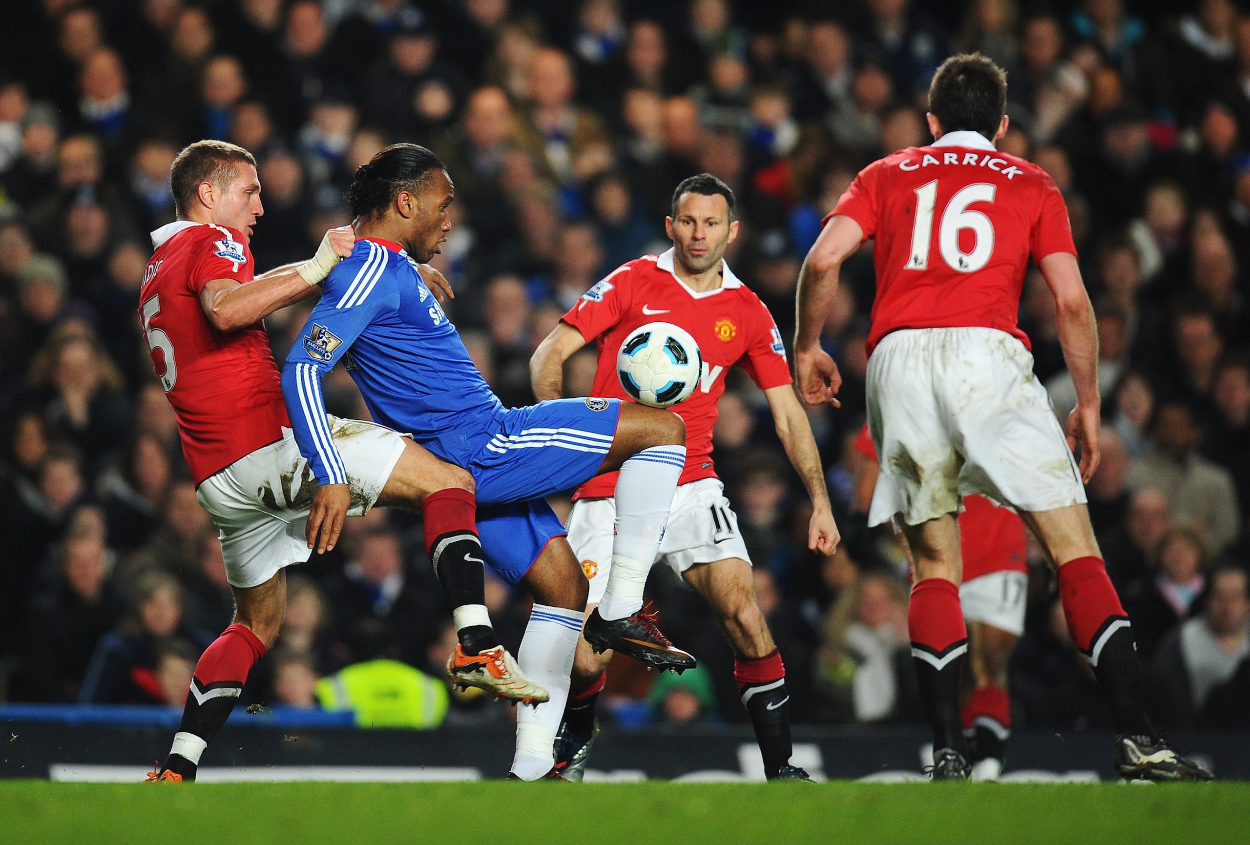 LONDON, ENGLAND - MARCH 01: Didier Drogba of Chelsea holds the ball up watched by Nemanja Vidic (L), Ryan Giggs and Michael Carrick during the Barclays Premier League match between Chelsea and Manchester United at Stamford Bridge on March 1, 2011 in Lond LONDON, ENGLAND - MARCH 01: Didier Drogba of Chelsea holds the ball up watched by Nemanja Vidic (L), Ryan Giggs and Michael Carrick during the Barclays Premier League match between Chelsea and Manchester United at Stamford Bridge on March 1, 2011 in Lond