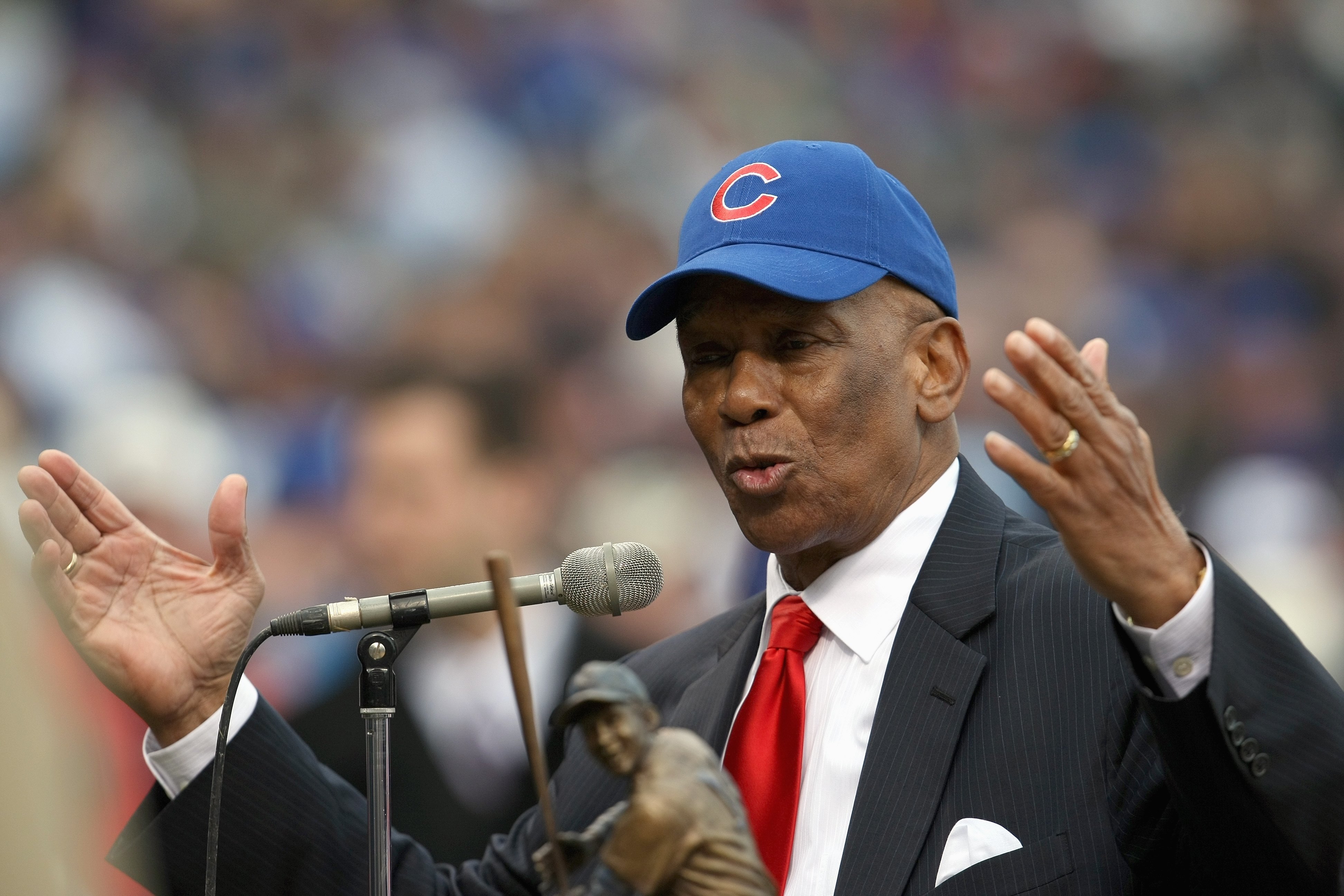 CHICAGO - MARCH 31: Ernie Banks speaks before he throws out a ceremonial first pitch before the Cubs take on the Milwaukee Brewers during the Opening Day game at Wrigley Field on March 31, 2008 in Chicago, Illinois. (Photo by Jonathan Daniel/Getty Images)