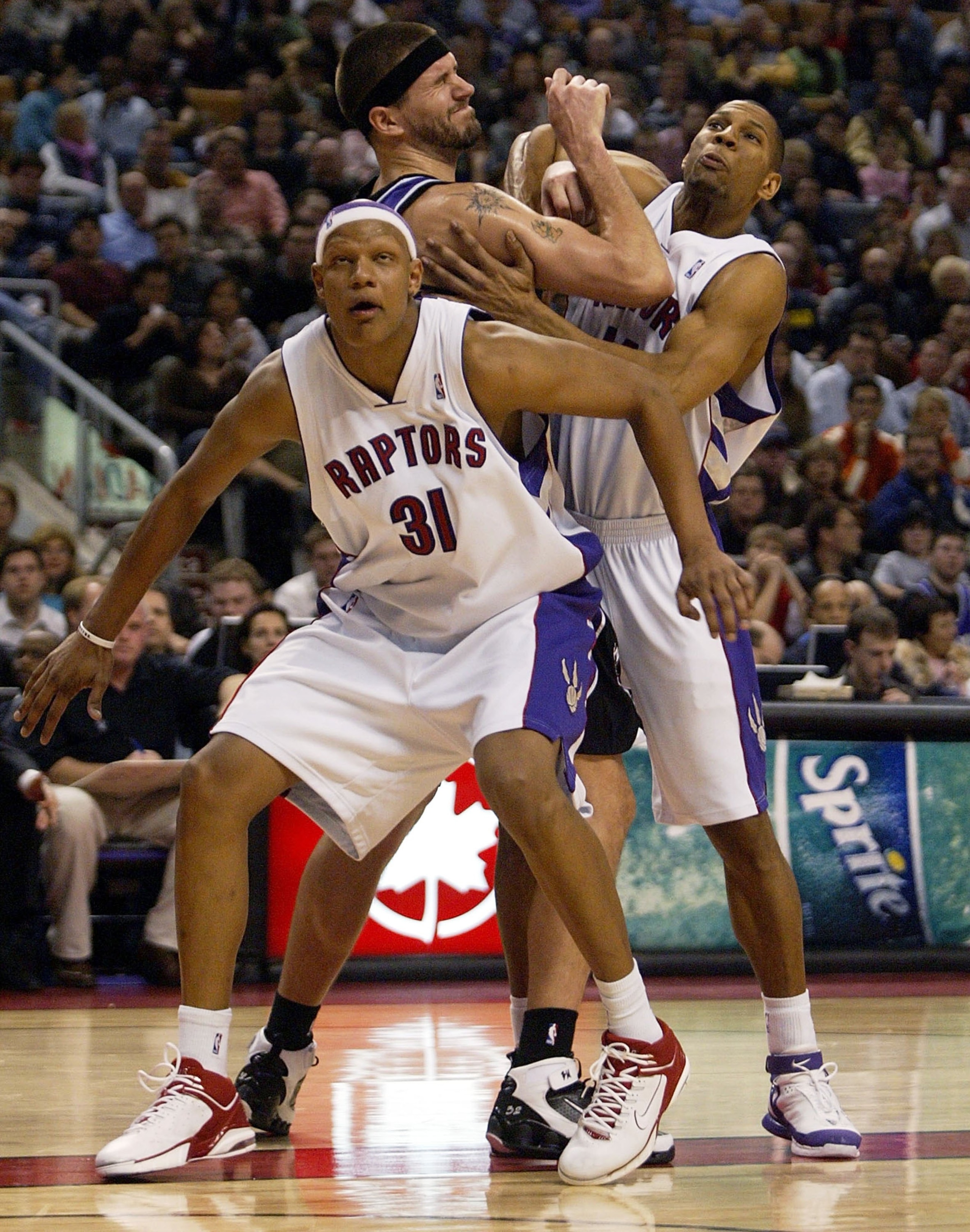 TORONTO - JANUARY 29:  Brad Miller #52 of the Sacramento Kings battles for position against Charlie Villanueva #31 and Joey Graham #14 of the Torotnto Raptors at the Air Canada Centre January 29, 2006 in Toronto, Ontario, Canada. The Raptors beat the King