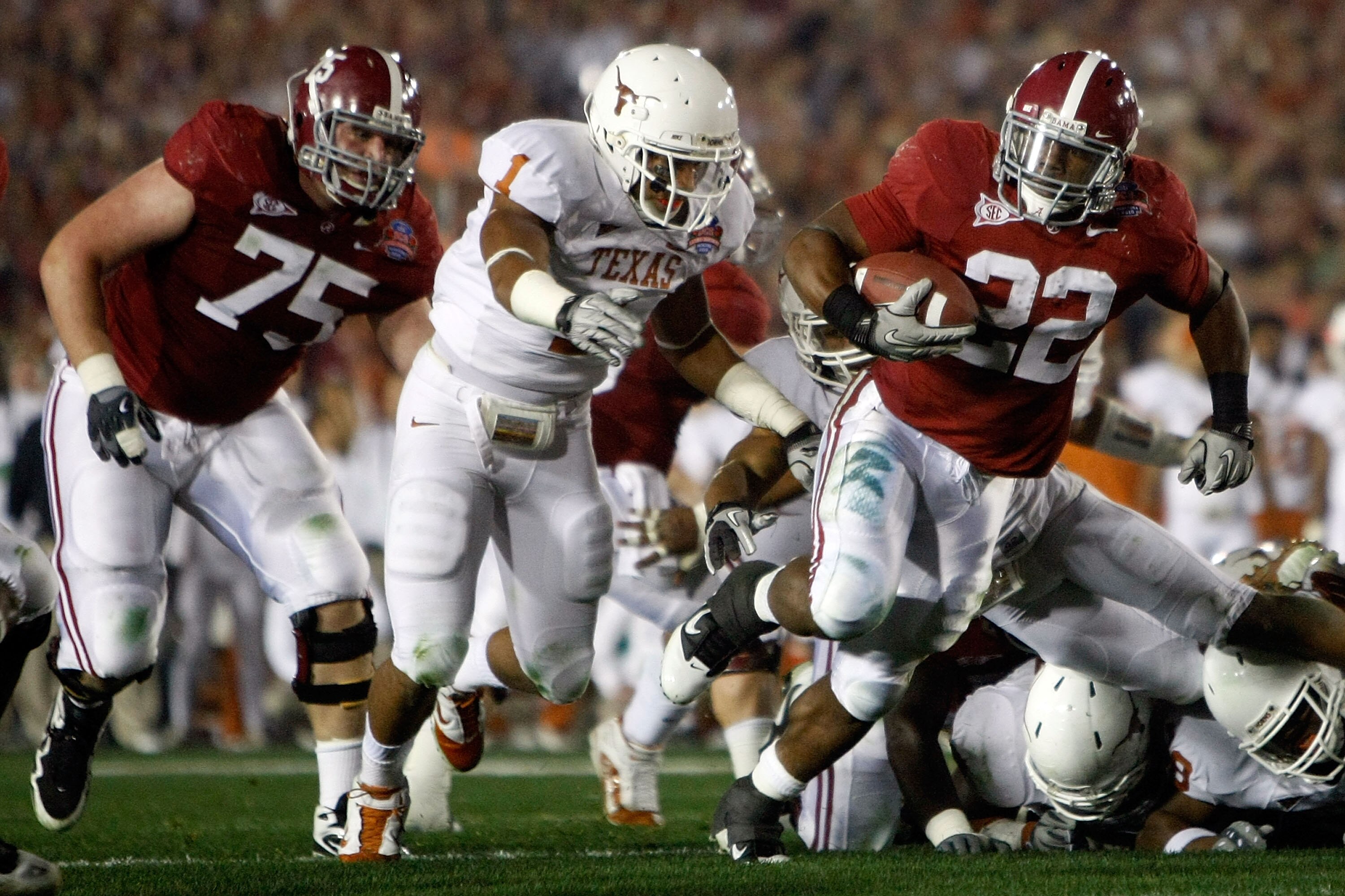 PASADENA, CA - JANUARY 07: Running back Mark Ingram #22 of the Alabama Crimson Tide runs with the ball as Keenan Robinson #1 of the Texas Longhorns tries to tackle during the Citi BCS National Championship game at the Rose Bowl on January 7, 2010 in Pasa PASADENA, CA - JANUARY 07: Running back Mark Ingram #22 of the Alabama Crimson Tide runs with the ball as Keenan Robinson #1 of the Texas Longhorns tries to tackle during the Citi BCS National Championship game at the Rose Bowl on January 7, 2010 in Pasa