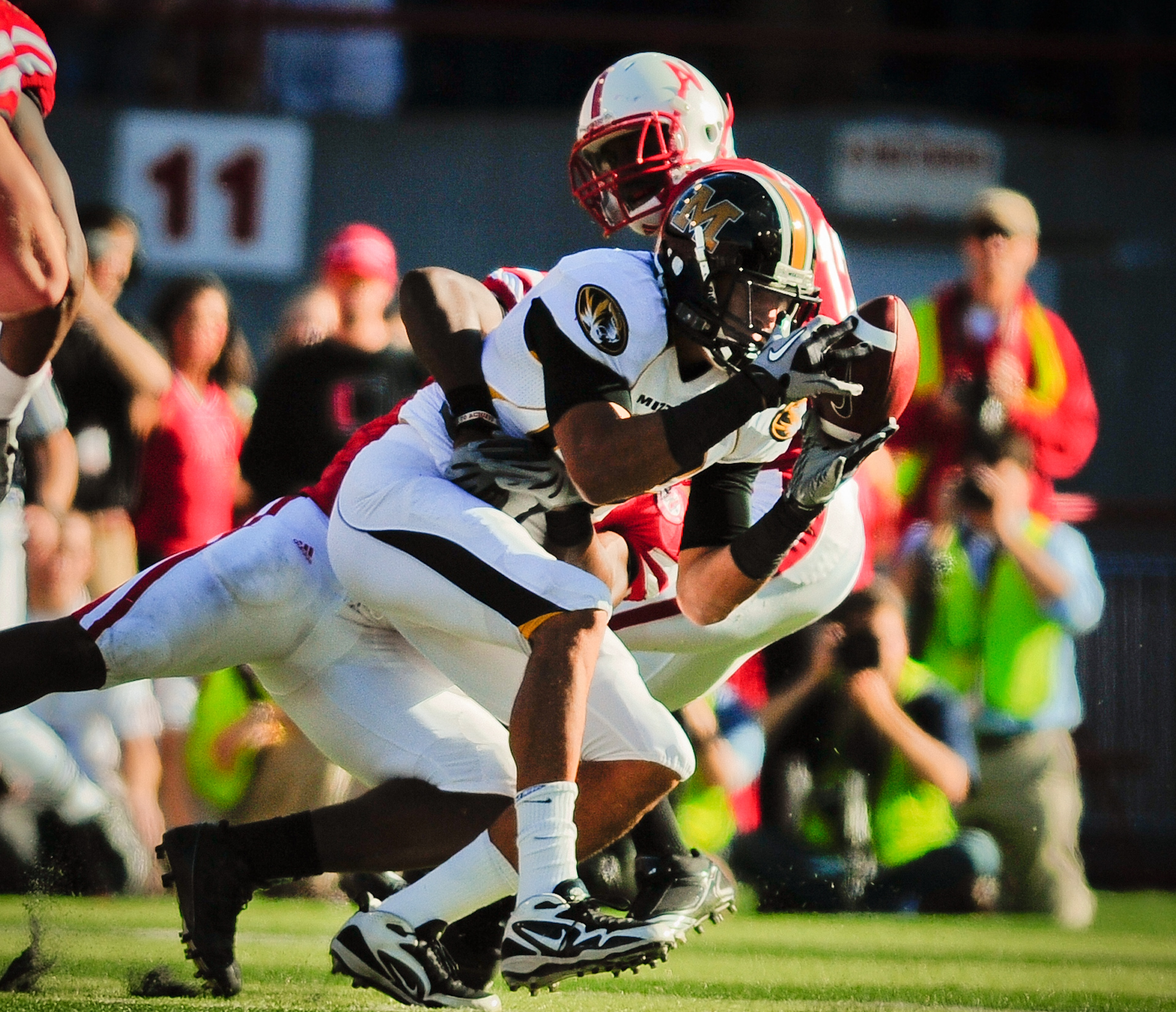 LINCOLN, NE - OCTOBER 30: Tight end Michael Egnew #82 of the Missouri Tigers attempts to haul in a pass against the Nebraska Cornhuskers defense during second half action of their game at Memorial Stadium on October 30, 2010 in Lincoln, Nebraska. Nebraska