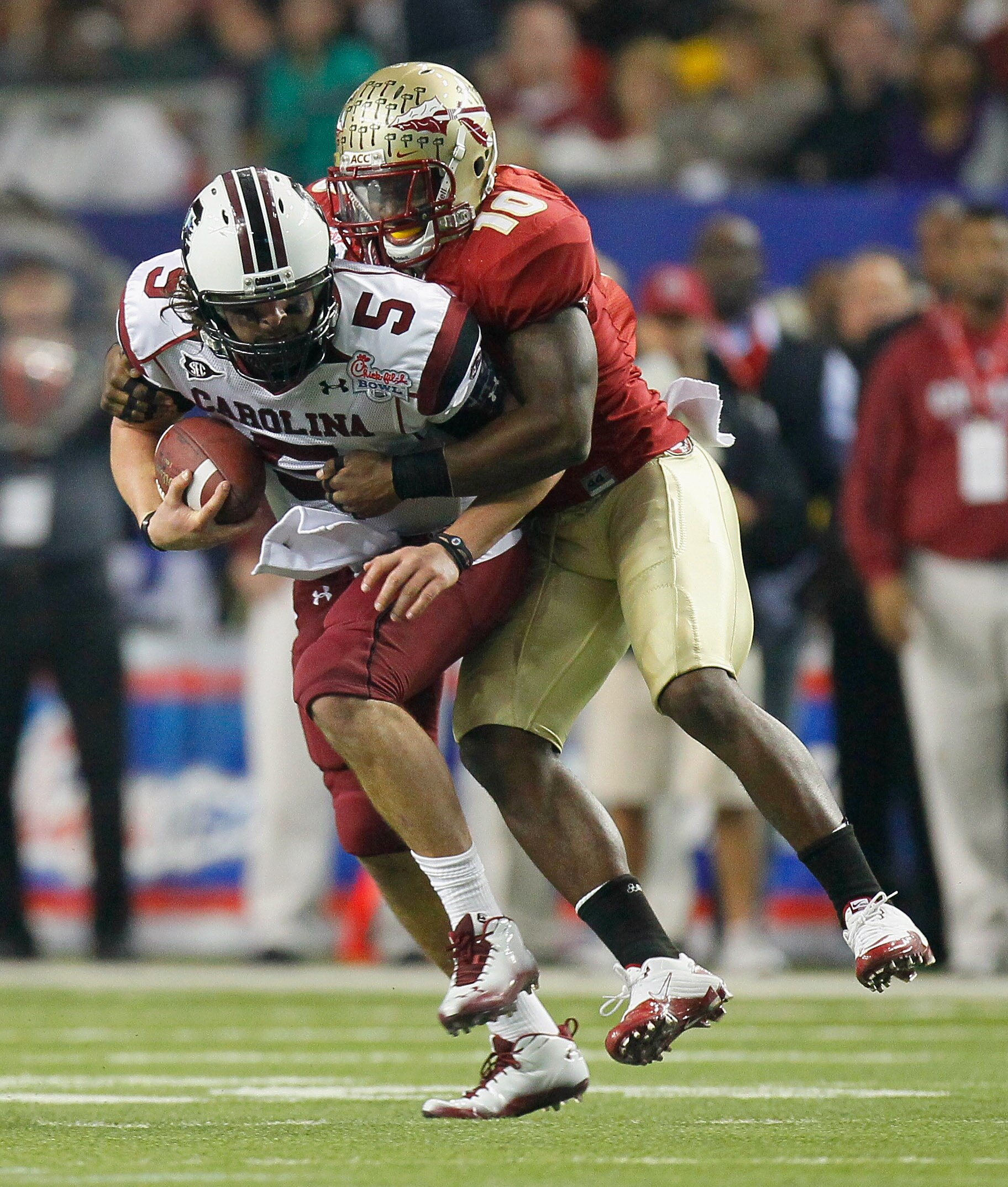 ATLANTA, GA - DECEMBER 31:  Nick Moody #10 of the Florida State Seminoles tackles quarterback Stephen Garcia #5 of the South Carolina Gamecocks during the 2010 Chick-fil-A Bowl at Georgia Dome on December 31, 2010 in Atlanta, Georgia.  (Photo by Kevin C.