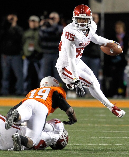 WR Ryan Broyles hurdles a Cowboy defender.
