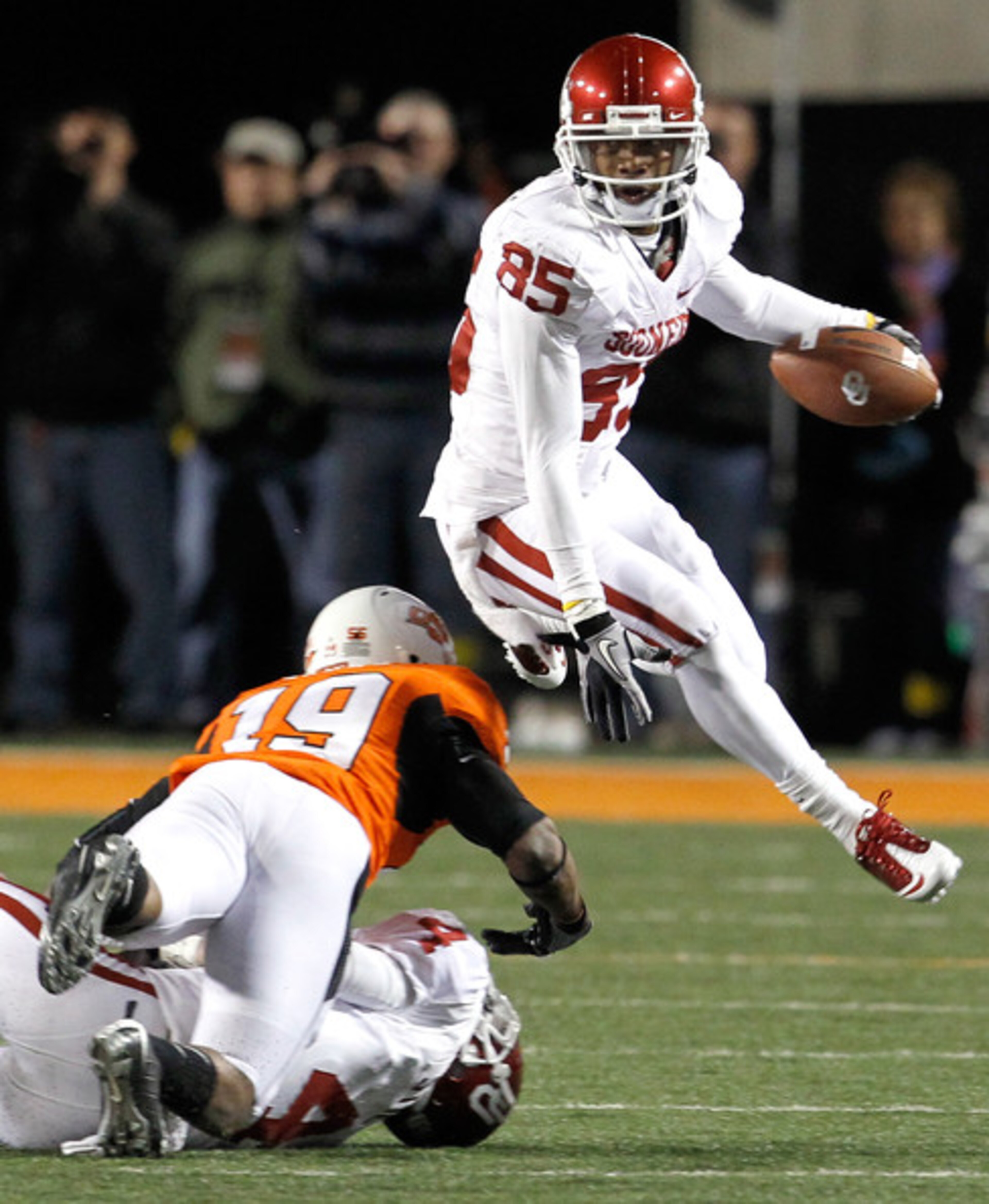 WR Ryan Broyles hurdles a Cowboy defender.