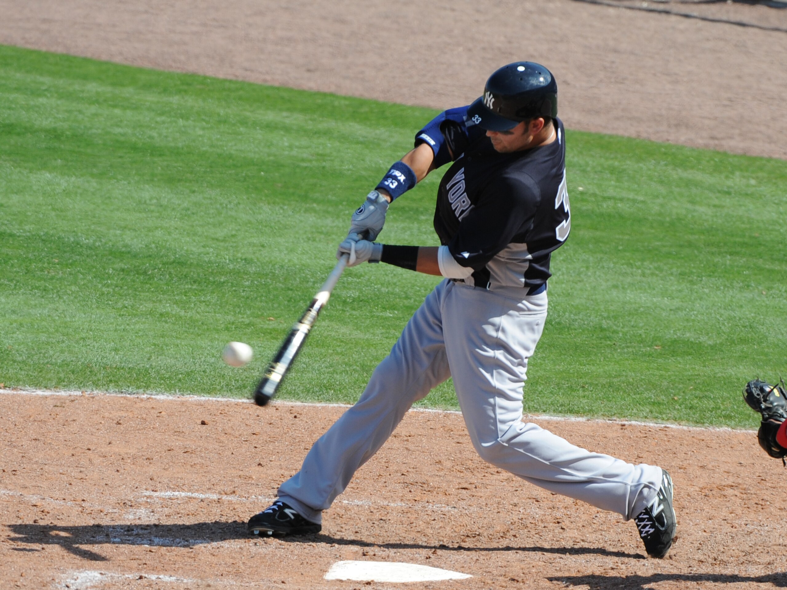 CLEARWATER, FL - FEBRUARY 27:  Outfielder Nick Swisher #33 of the New York Yankees doubles against the Philadelphia Phillies February 27, 2011 at Bright House Field in Clearwater, Florida.  (Photo by Al Messerschmidt/Getty Images)