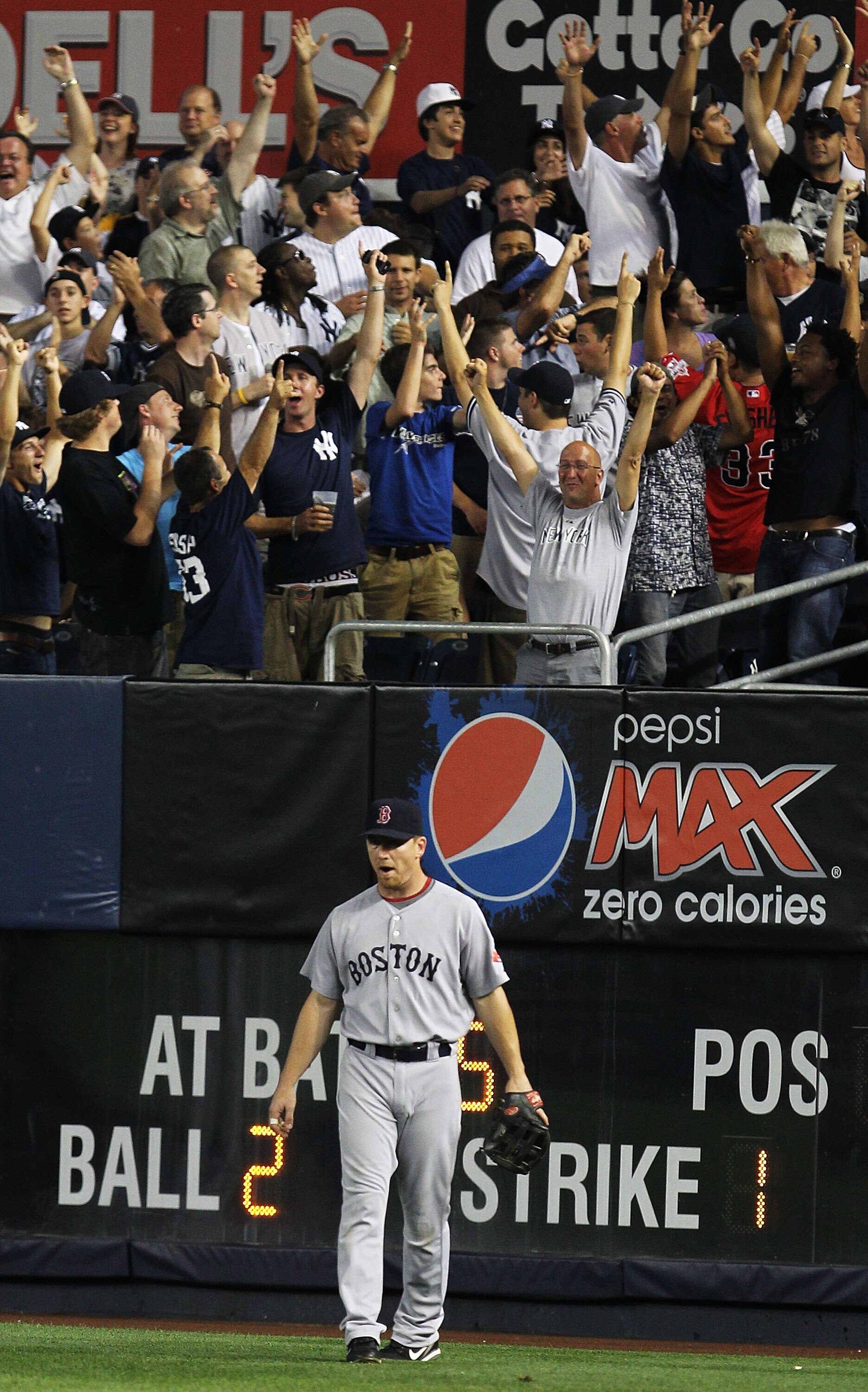 NEW YORK - AUGUST 08:  J.D. Drew of the Boston Red Sox looks on after Mark Teixeira of the New York Yankees hit a home run in the fifth inning uring their game on August 8, 2010 at Yankee Stadium in the Bronx borough of New York City.  (Photo by Al Bello/