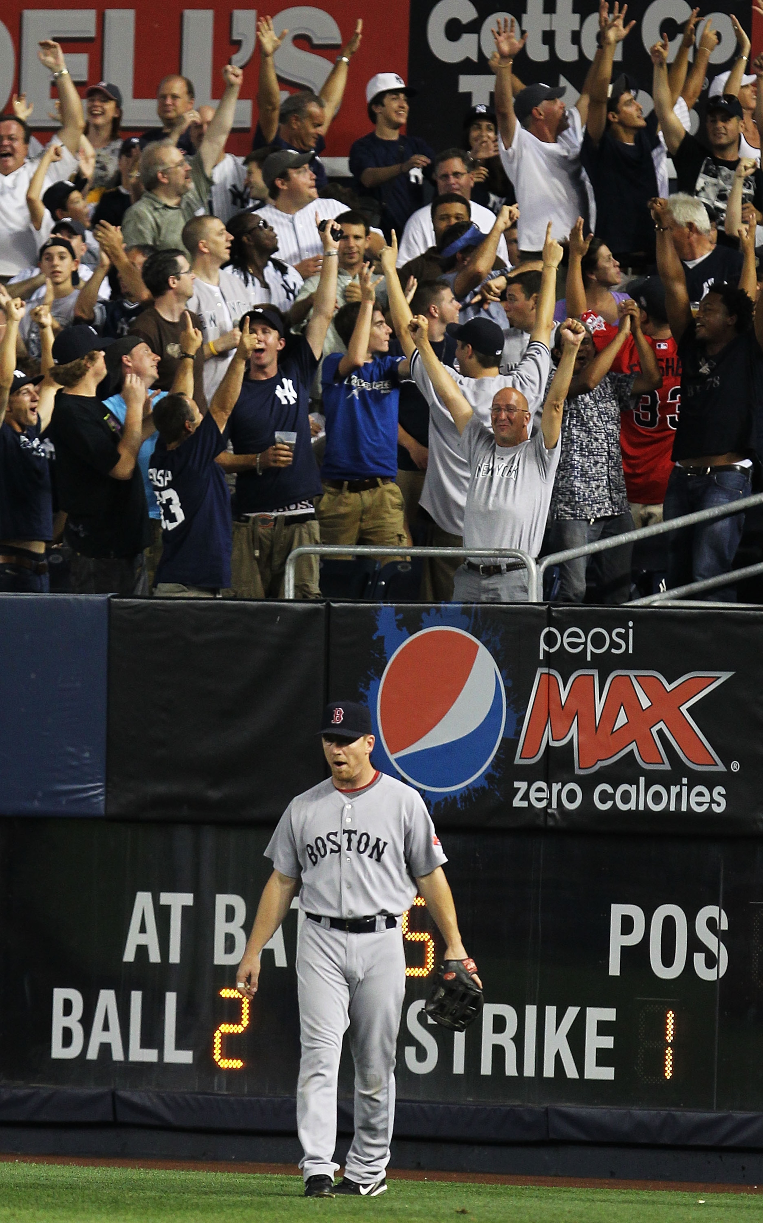 NEW YORK - AUGUST 08:  J.D. Drew of the Boston Red Sox looks on after Mark Teixeira of the New York Yankees hit a home run in the fifth inning uring their game on August 8, 2010 at Yankee Stadium in the Bronx borough of New York City.  (Photo by Al Bello/