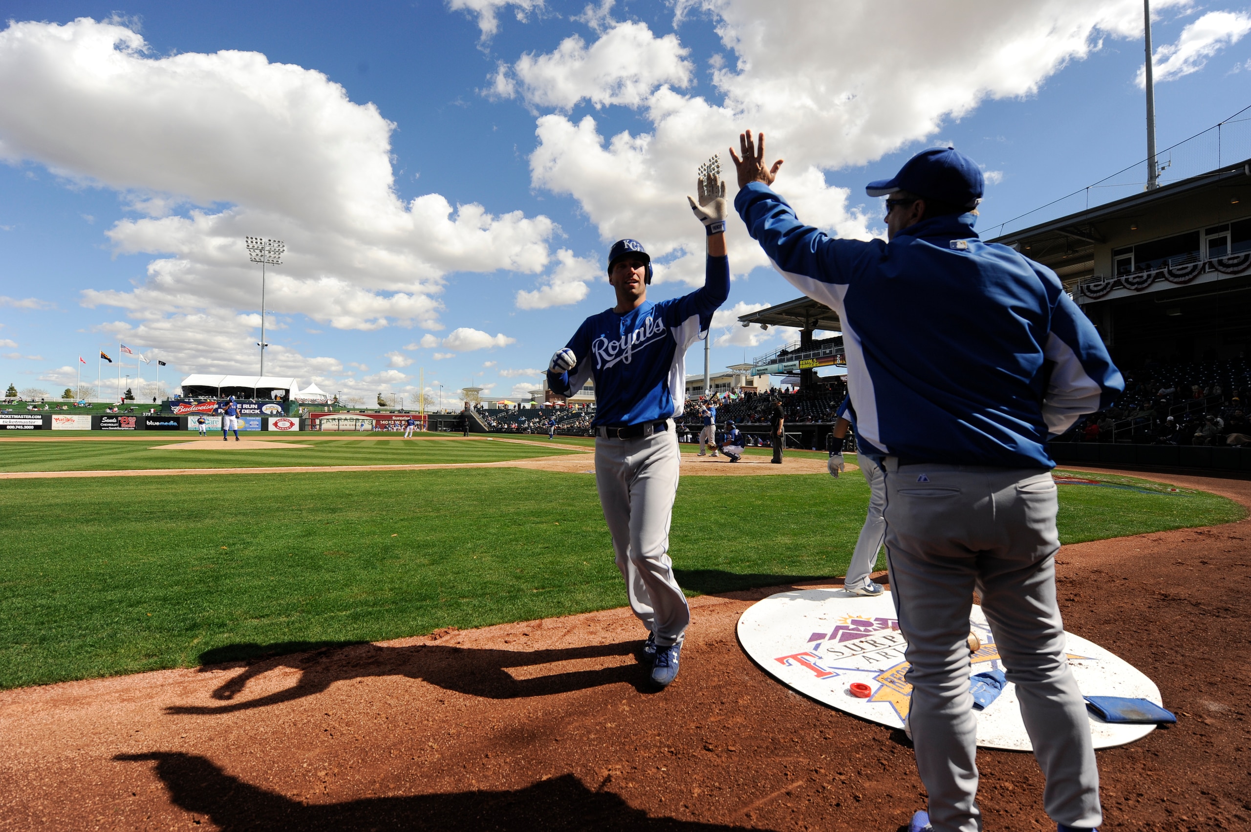 SURPISE, AZ - FEBRUARY 27: Jeff Francoeur #21 of the Kansas City Royals gets greeted with a h five at the dugout after hitting a home run during a spring training game against the Texas Rangers at Surprise Stadium on February 27, 2011 in Surprise, Arizona