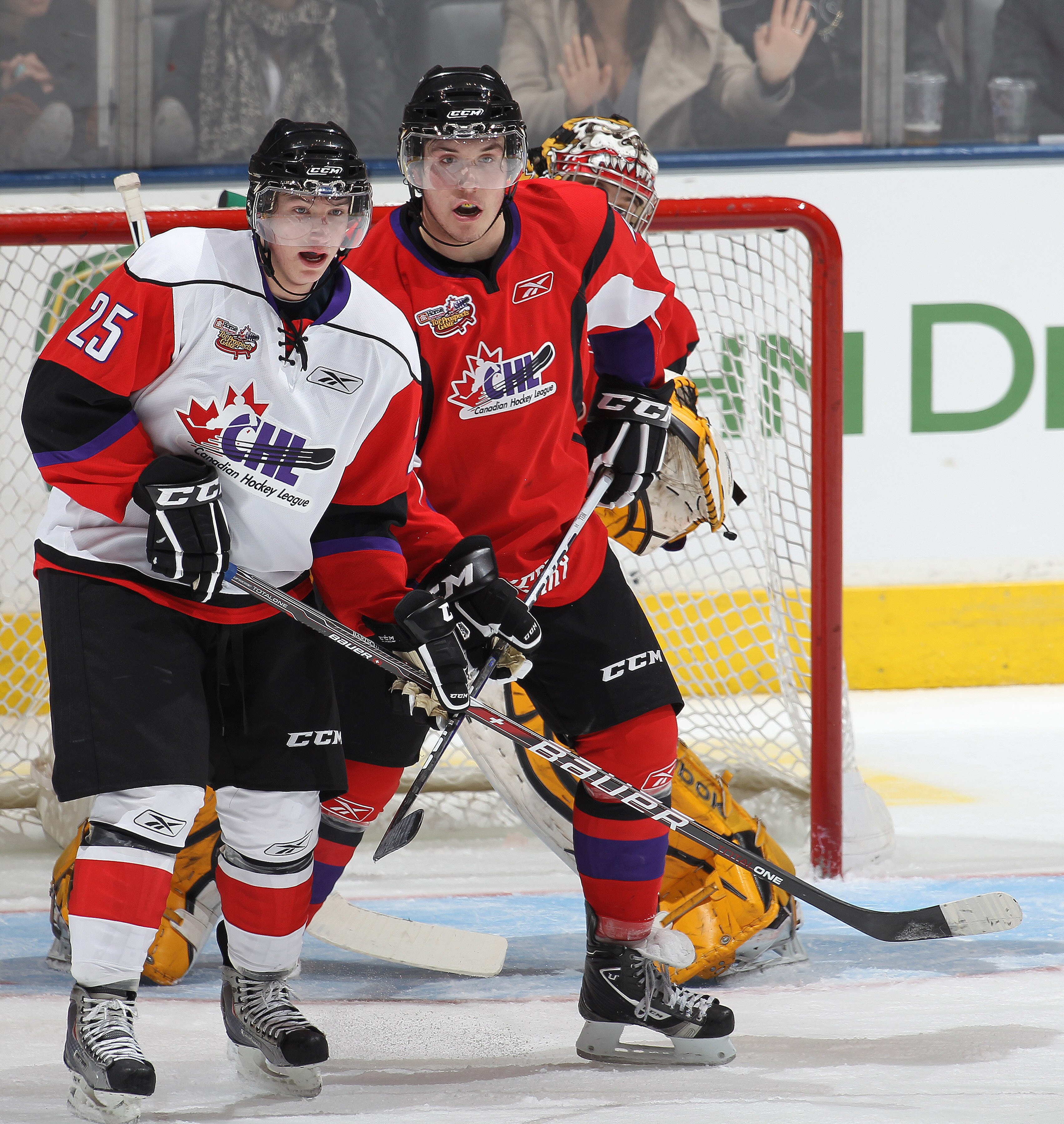 TORONTO, CAN - JANUARY 19:  Myles Bell #4 of Team Cherry holds Sven Bartschi #25 of Team Orr in check in the 2011 Home Hardware Top Prospects game on January 19, 2011 at the Air Canada Centre in Toronto, Canada. Team Orr defeated Team Cherry 7-1. (Photo b