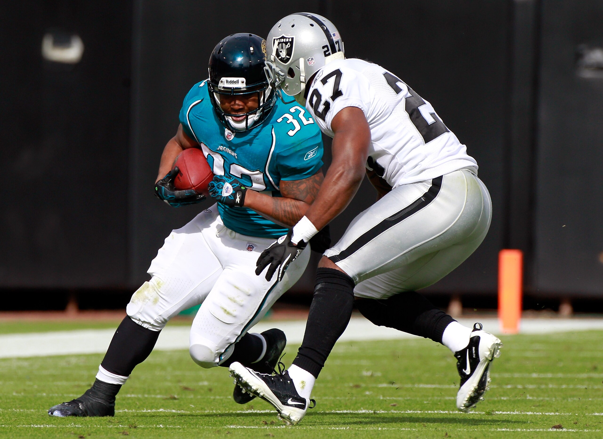 JACKSONVILLE, FL - DECEMBER 12:  Maurice Jones-Drew #32 of the Jacksonville Jaguars runs against Stevie Brown #27 of the Oakland Raiders during the game at EverBank Field on December 12, 2010 in Jacksonville, Florida.  (Photo by Sam Greenwood/Getty Images