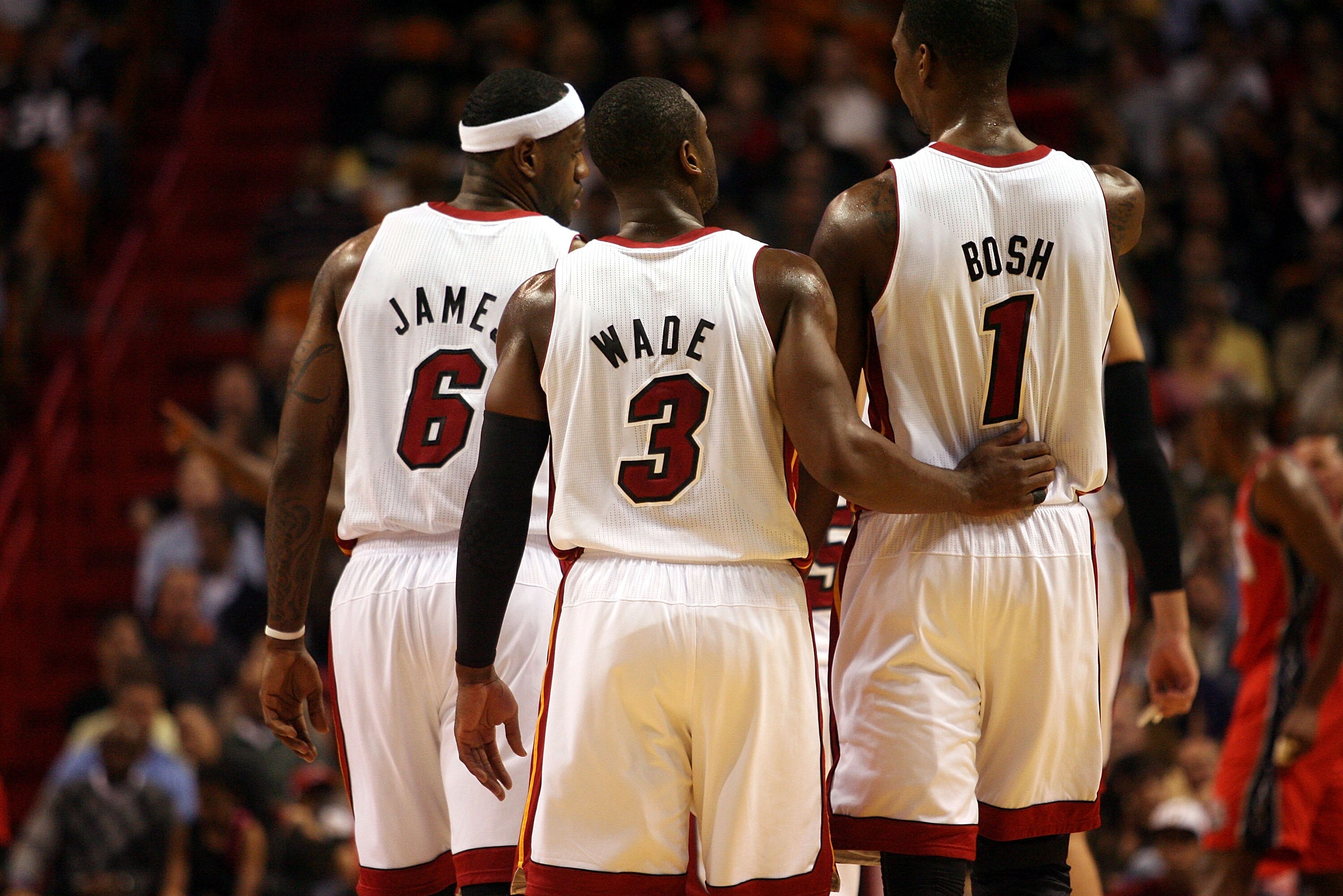 MIAMI - NOVEMBER 06:  Dwyane Wade #3, LeBron James #6 and Chris Bosh #1 of the Miami Heat chat during a game against the New Jersey Nets  at American Airlines Arena on November 6, 2010 in Miami, Florida. NOTE TO USER: User expressly acknowledges and agree