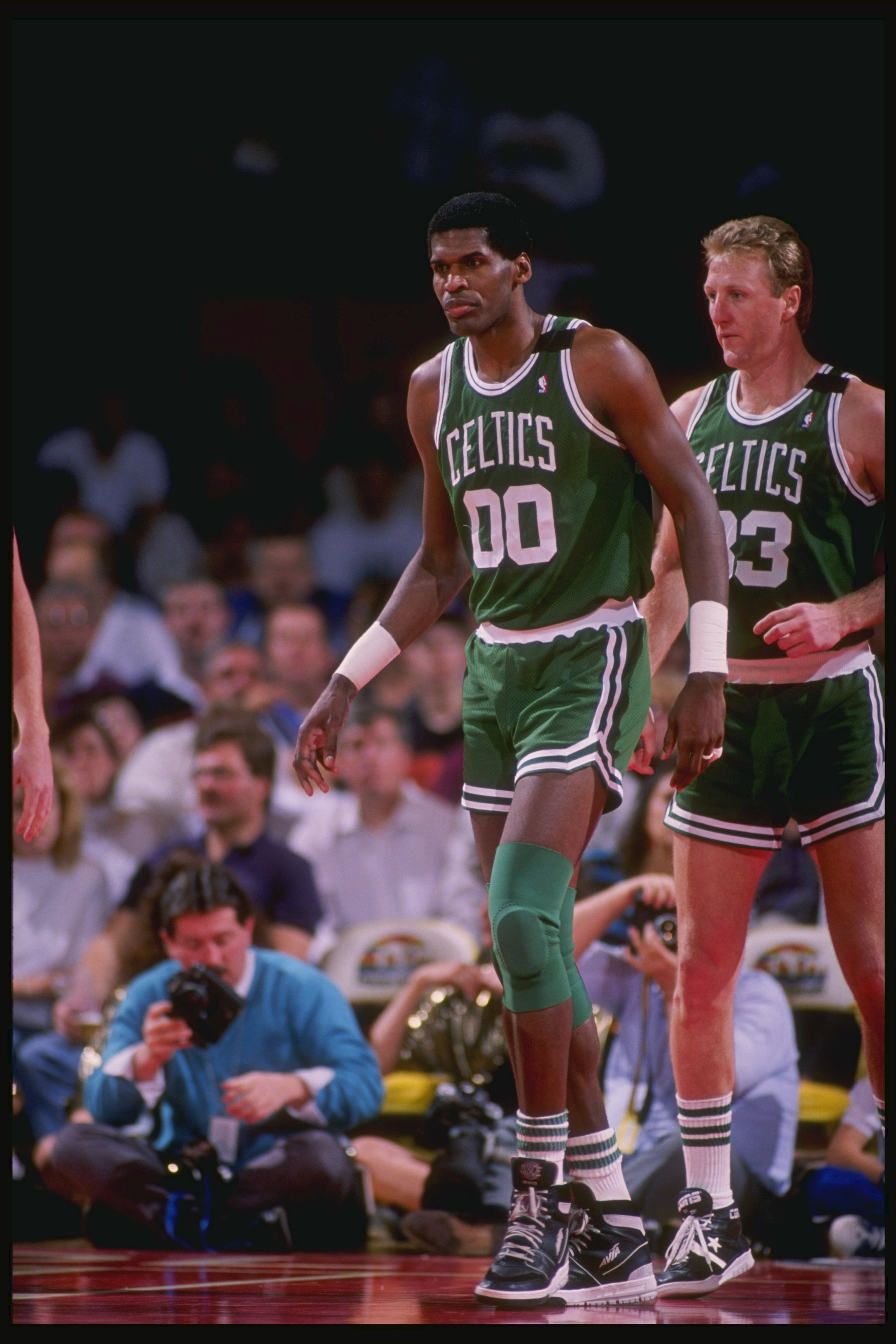 1990:  Center Robert Parish and forward Larry Bird of the Boston Celtics walk down the court during a game. Mandatory Credit: Tim de Frisco  /Allsport