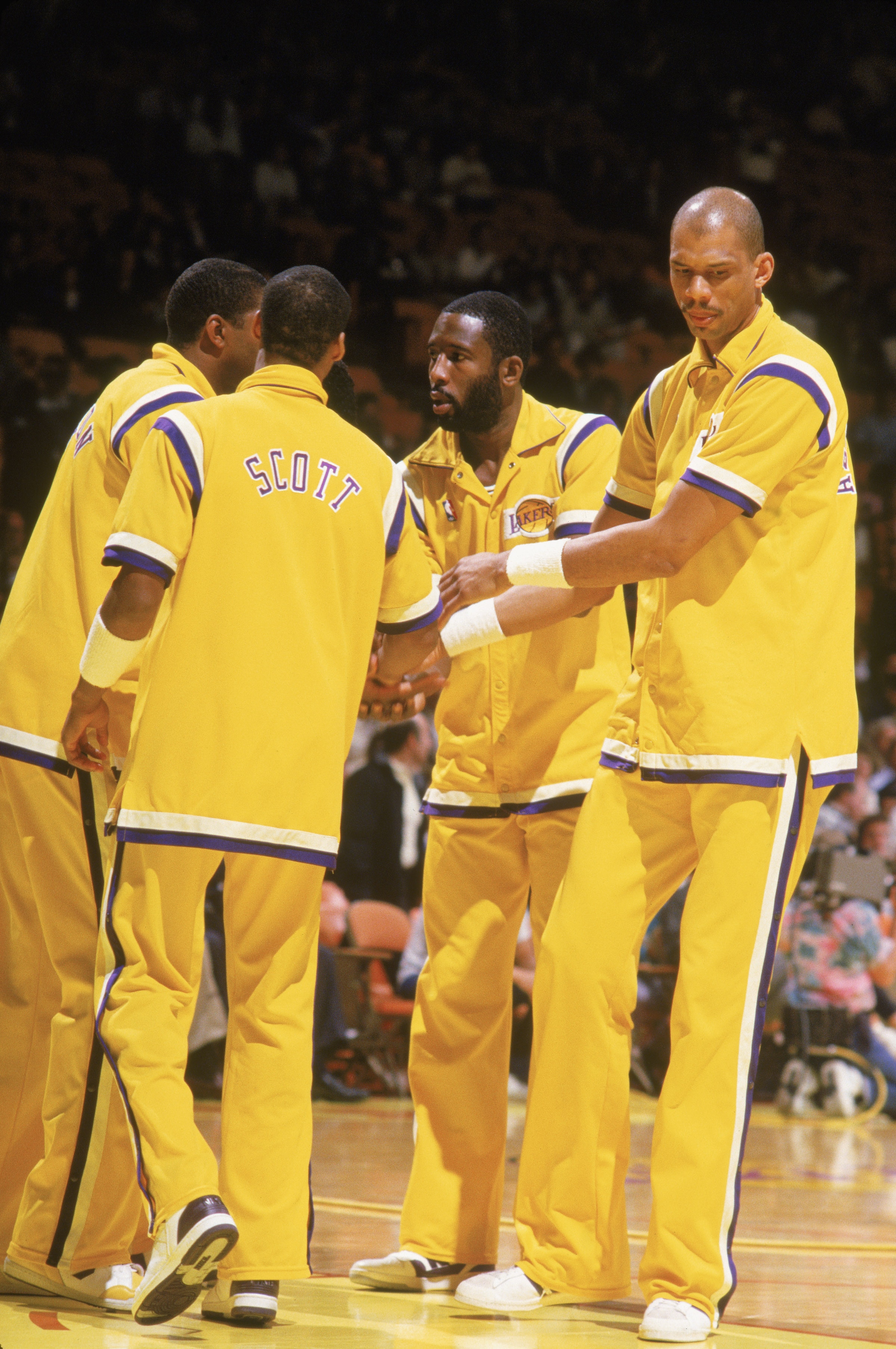 LOS ANGELES - 1988:  Magic Johnson #32, Byron Scott #4, James Worthy #42 and Kareem Abdul-Jabbar #33 of the Los Angeles Lakers huddle before an NBA game at the Great Western Forum in Los Angeles, California in 1988. (Photo by Jonathan Daniel/Getty Images)
