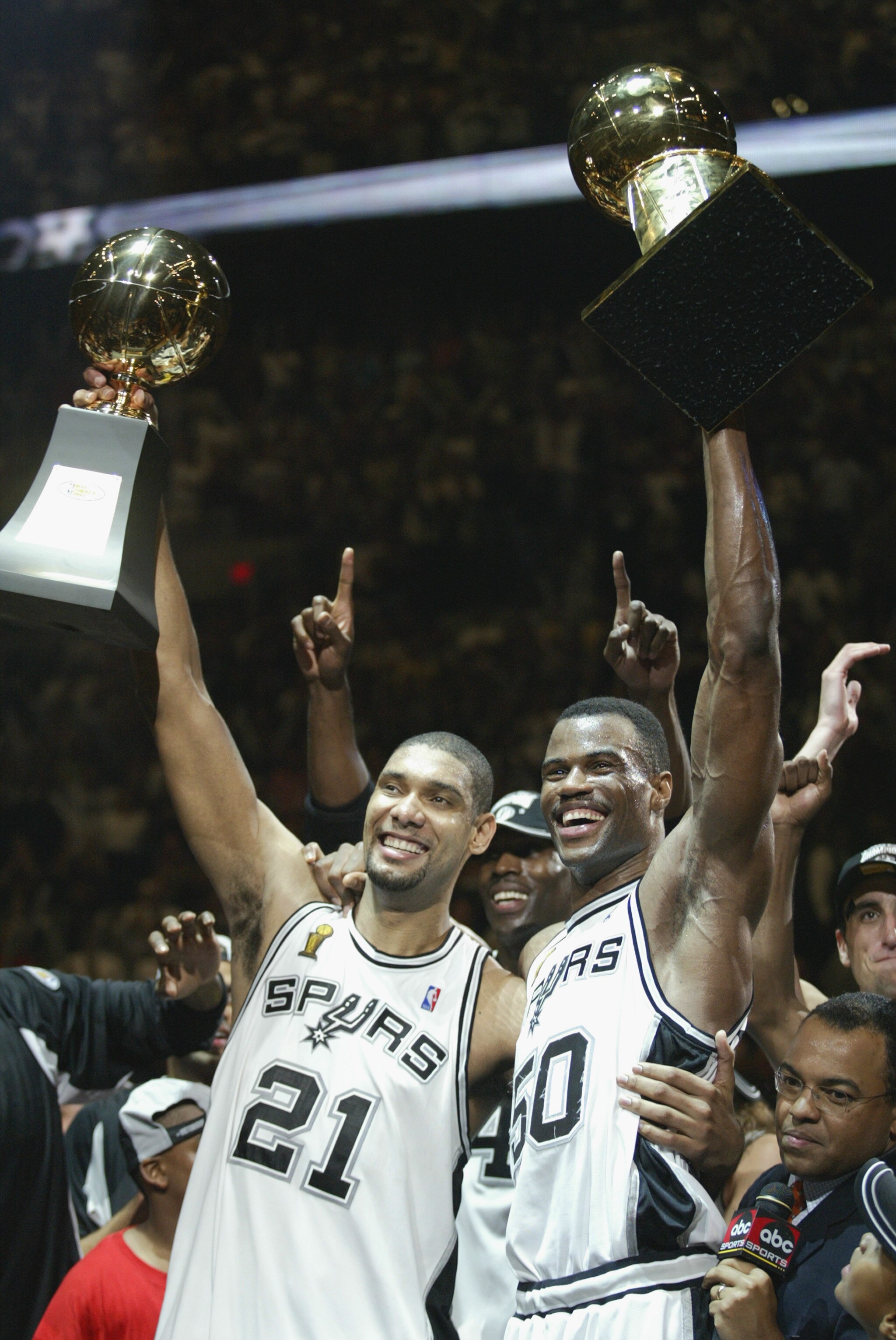 SAN ANTONIO, TX - JUNE 15:  Tim Duncan #21 and David Robinson #50 of the San Antonio Spurs celebrate after winning Game six of the 2003 NBA Finals against the New Jersey Nets on June 15, 2003 at the SBC Center in San Antonio, Texas.  The Spurs won 88-77 a