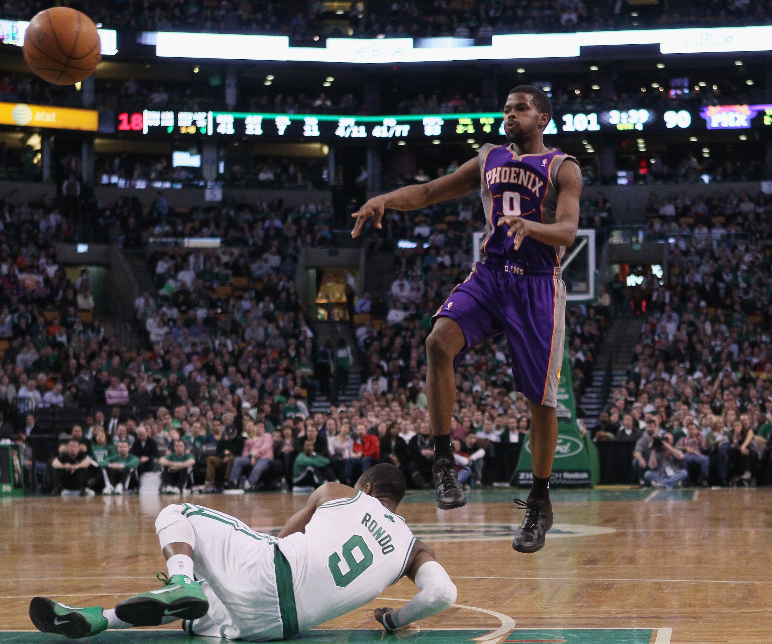 BOSTON, MA - MARCH 02:  Aaron Brooks #0 of the Phoenix Suns passes the ball over Rajon Rondo #9 of the Boston Celtics on March 2, 2011 at the TD Garden in Boston, Massachusetts.  The Celtics defeated the Suns 115-103. NOTE TO USER: User expressly acknowle