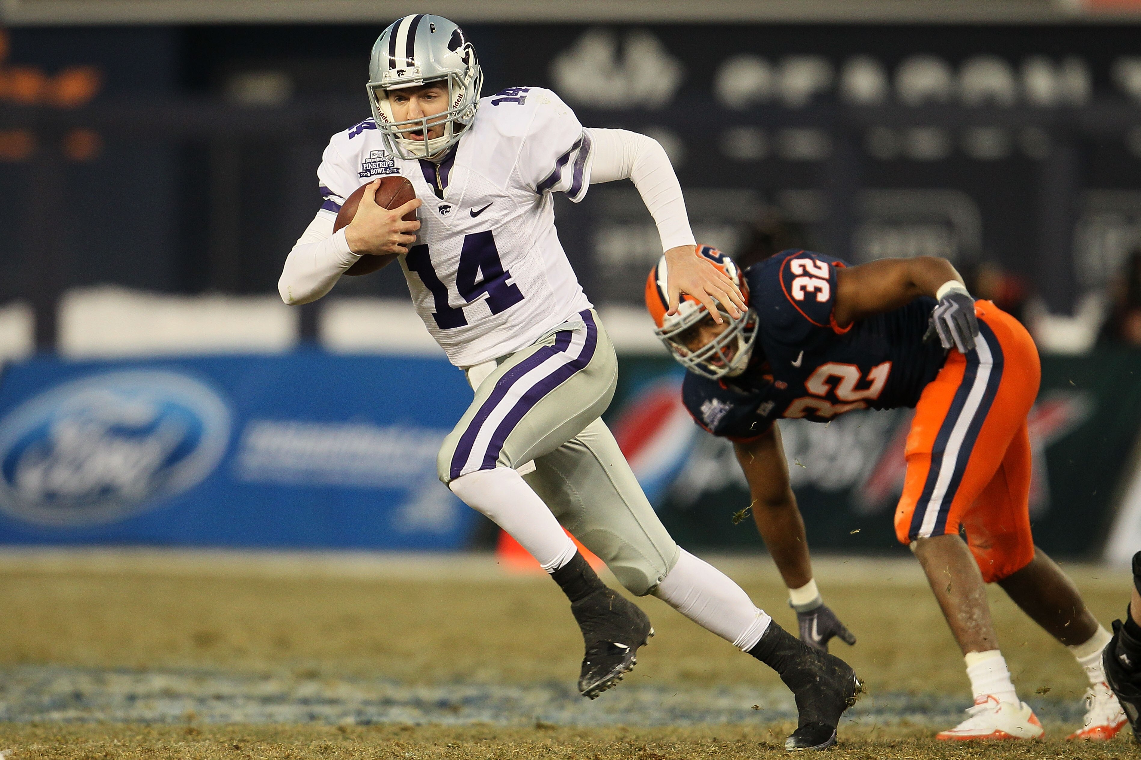 NEW YORK, NY - DECEMBER 30:  Carson Coffman #14 of the Kansas State Wildcats gets out of the tackle of Doug Hogue #32 of the Syracuse Orange during the New Era Pinstripe Bowl at Yankee Stadium on December 30, 2010 in New York, New York.  (Photo by Chris M