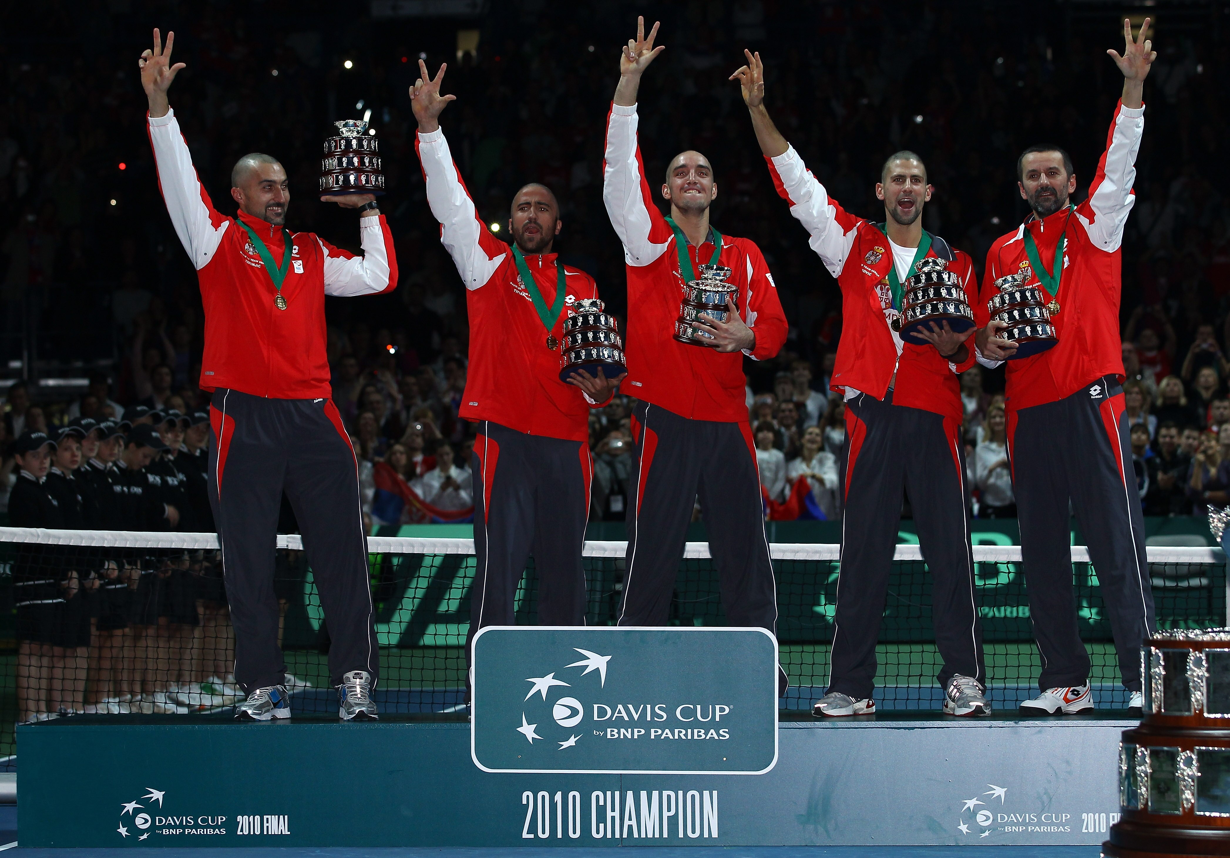 BELGRADE, SERBIA - DECEMBER 05:  (L-R) Nenad Zimonjic, Janko Tipsarevic, Viktor Troicki, Novak Djokovic, Bogdan Obradovic of Serbia celebrate with their trophies after defeating France during day three of the Davis Cup Tennis Final at the Begrade Arena on