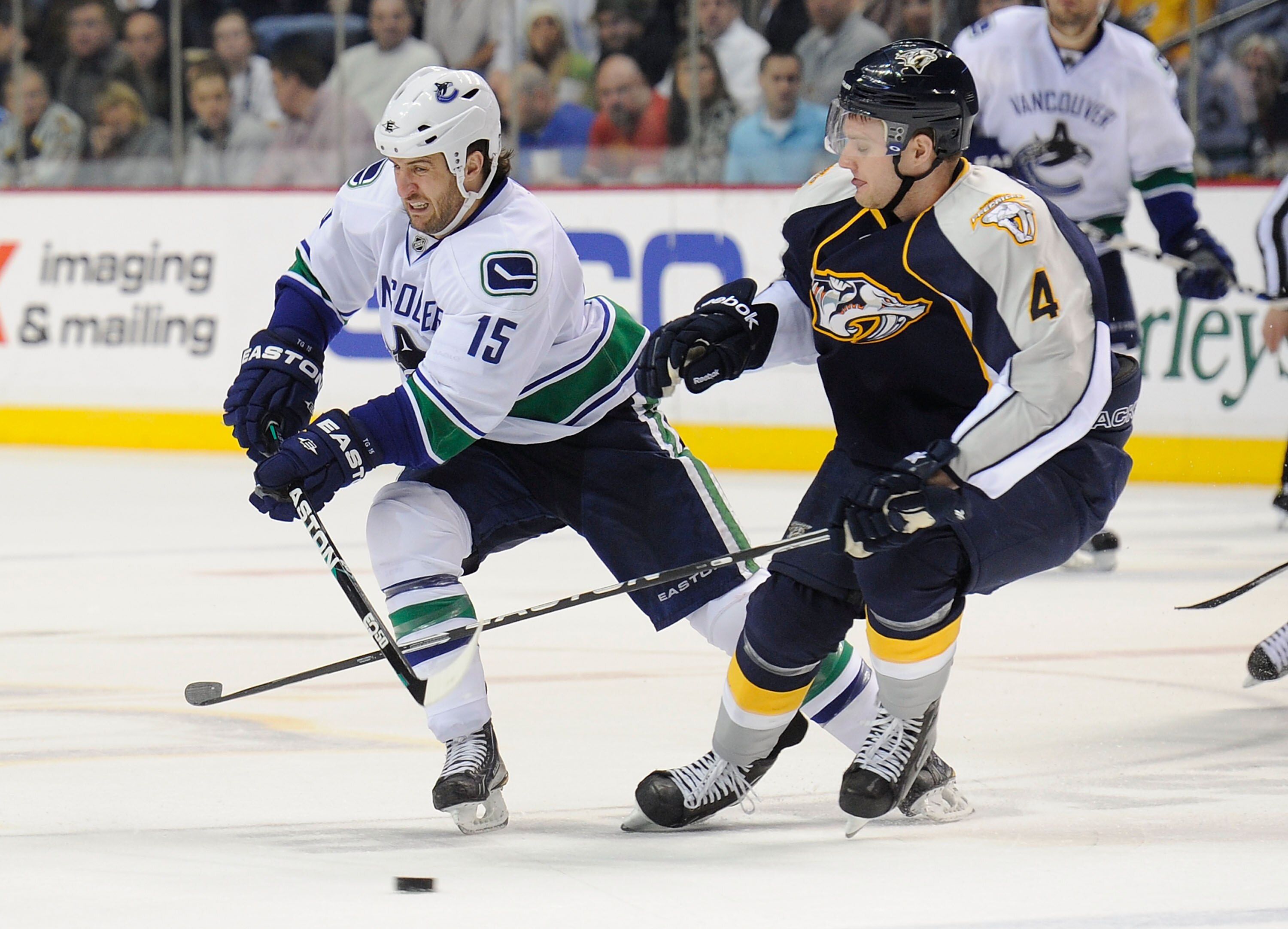 NASHVILLE, TN - FEBRUARY 17: Tanner Glass #15 of the Vancouver Canucks skates against Cody Franson #4 of the Nashville Predators on February 17, 2011 at the Bridgestone Arena in Nashville, Tennessee. (Photo by Frederick Breedon/Getty Images) NASHVILLE, TN - FEBRUARY 17: Tanner Glass #15 of the Vancouver Canucks skates against Cody Franson #4 of the Nashville Predators on February 17, 2011 at the Bridgestone Arena in Nashville, Tennessee. (Photo by Frederick Breedon/Getty Images)