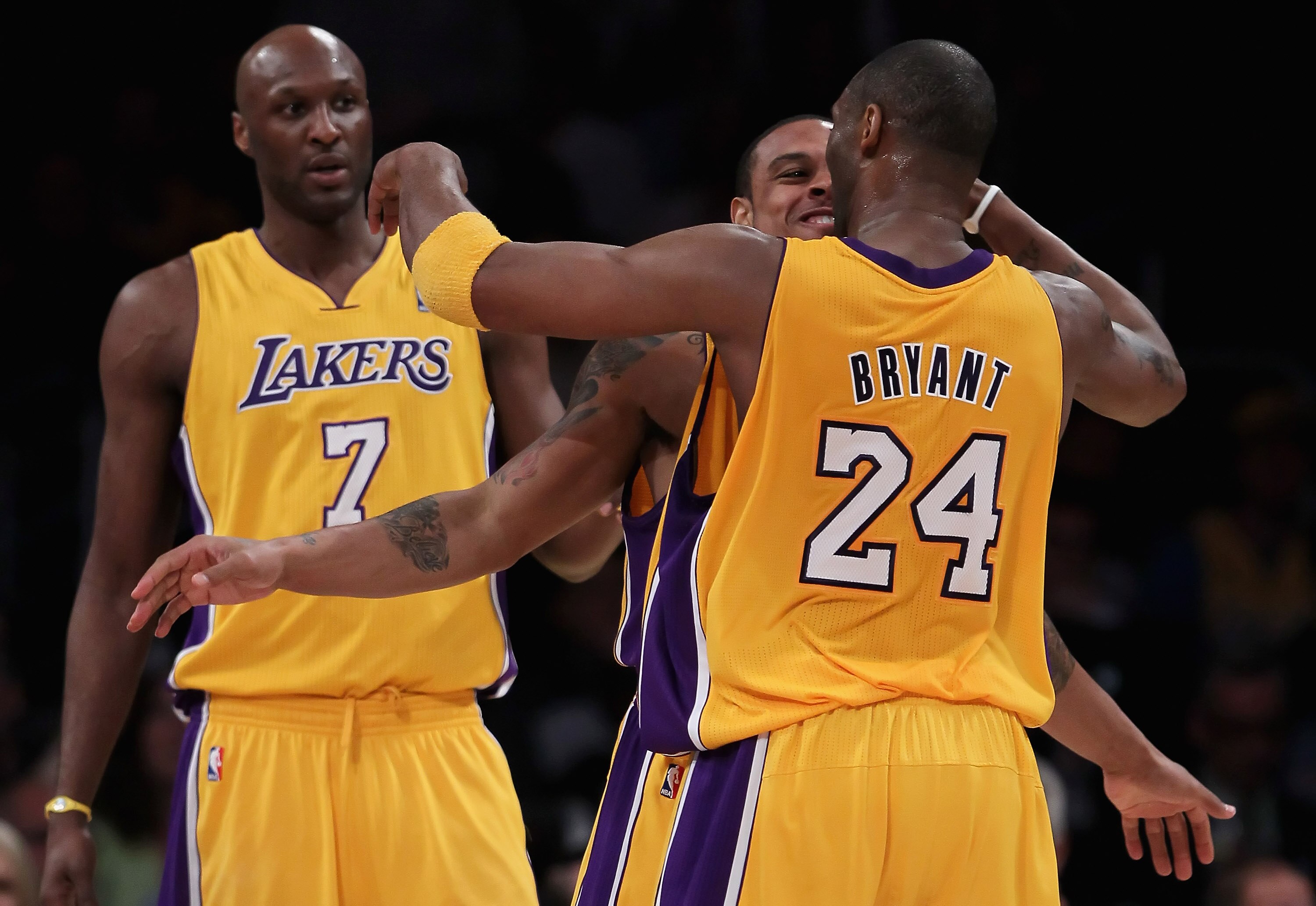 LOS ANGELES, CA - FEBRUARY 22:  (L-R) Lamar Odom #7, Shannon Brown #12 and Kobe Bryant #24 of the Los Angeles Lakers celebrate after Brown made a basket while being fouled against the Atlanta Hawks in the second half at Staples Center on February 22, 2011