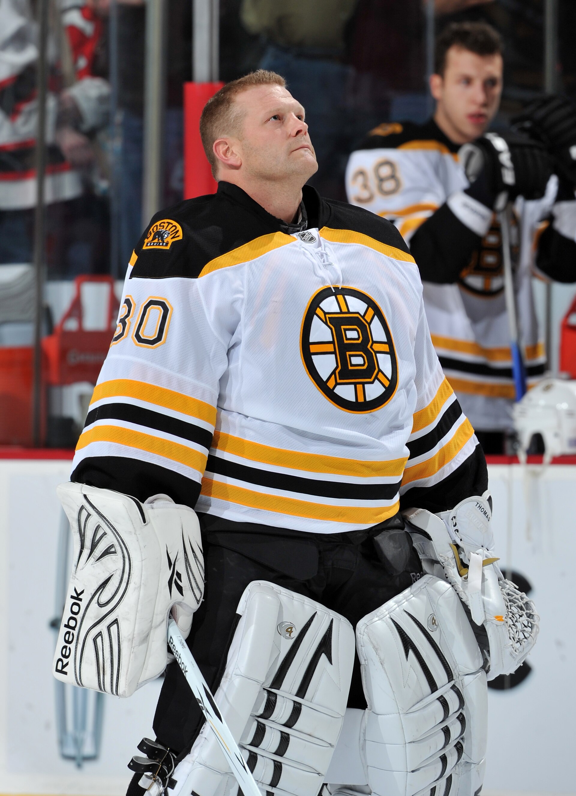 NEWARK, NJ - OCTOBER 16: Tim Thomas #30 of the Boston Bruins looks at the flag during the National Anthem prior to the game against the New Jersey Devils at the Prudential Center on October 16, 2010 in Newark, New Jersey. (Photo by Christopher Pasatieri/G