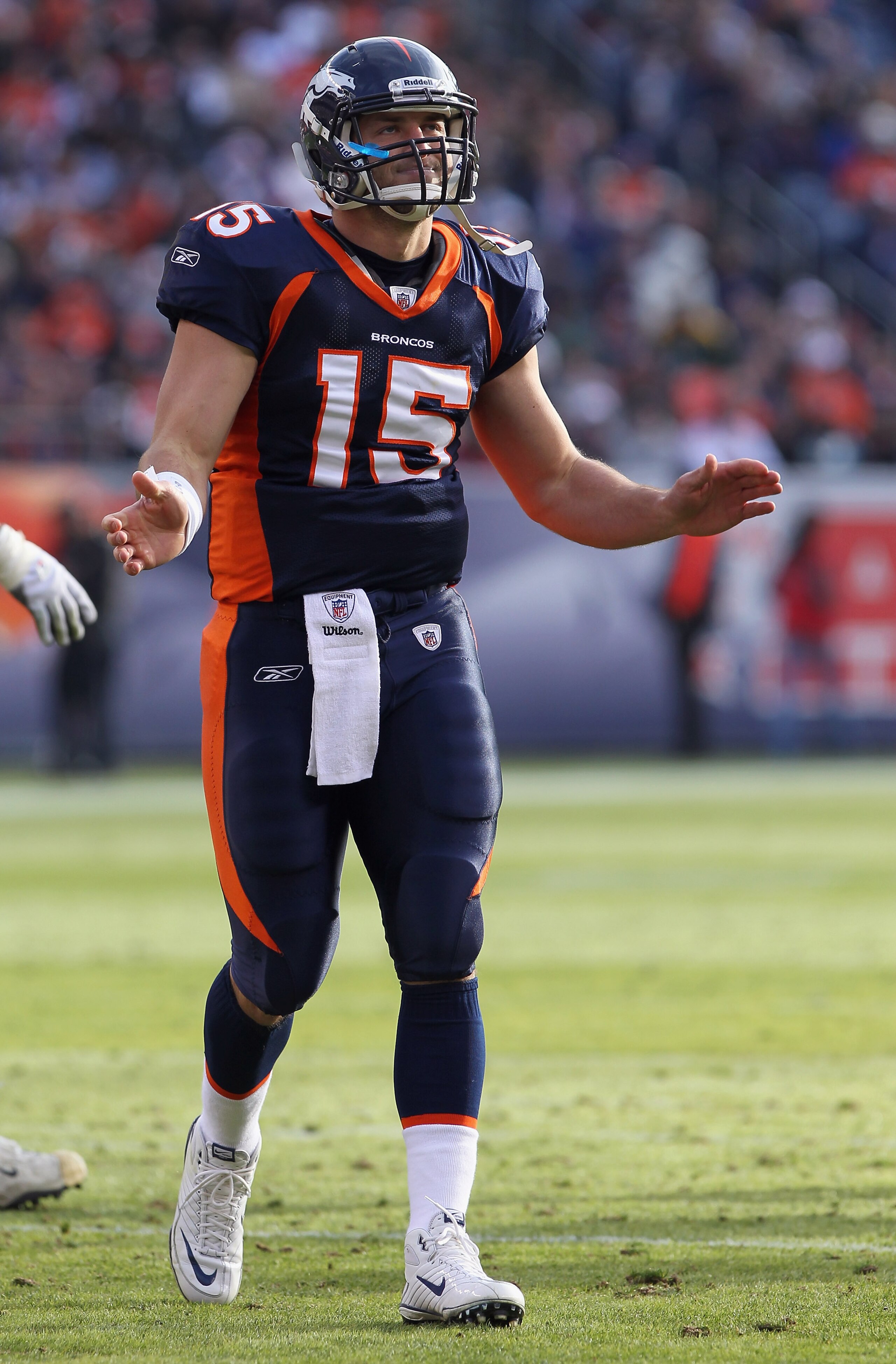 DENVER - DECEMBER 26:  Quarterback Tim Tebow #15 of the Denver Broncos reacts after throwing a first quarter touchdown against the Houston Texans at INVESCO Field at Mile High on December 26, 2010 in Denver, Colorado. The Broncos defeated the Texans 24-23