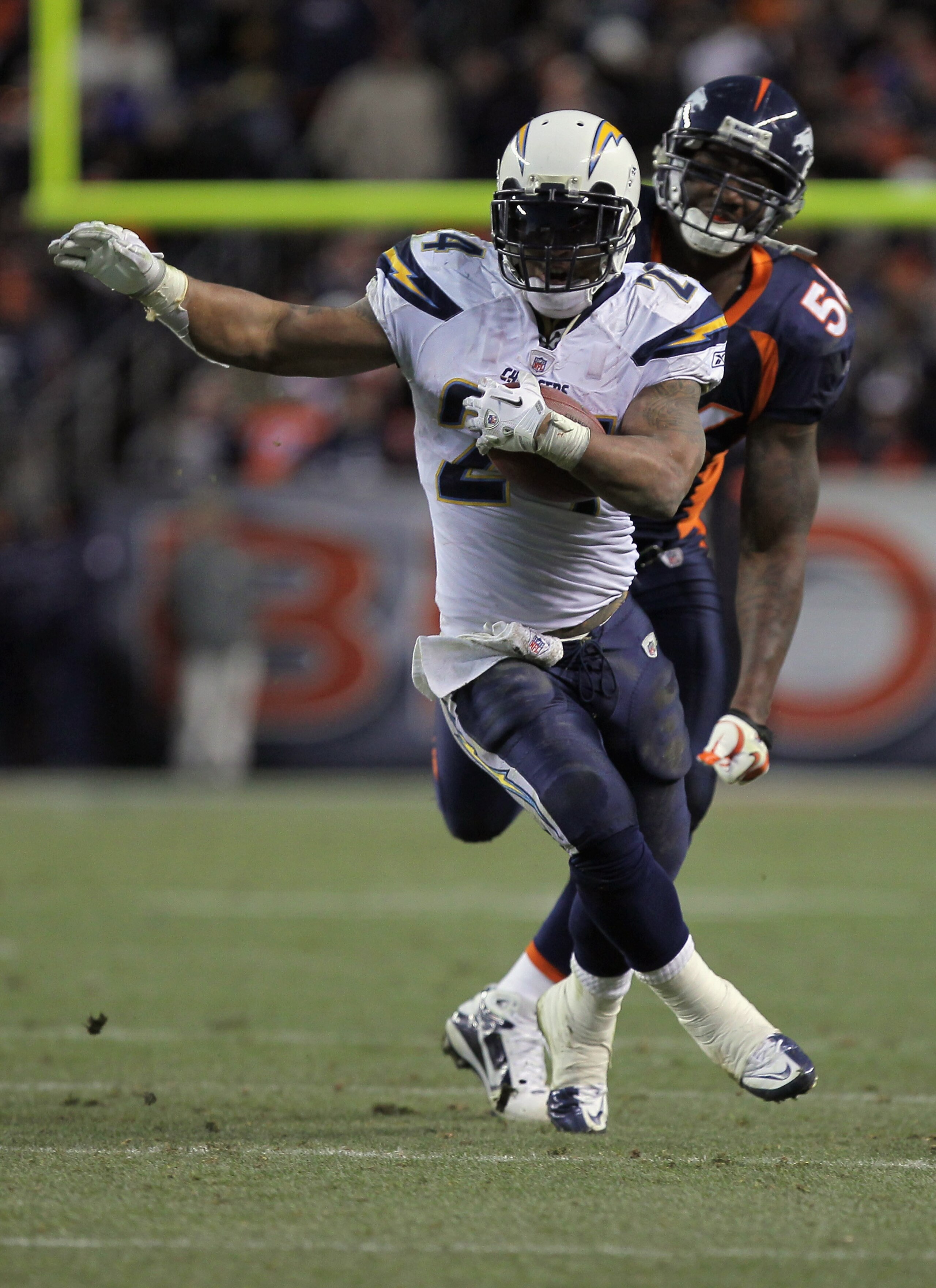 DENVER - JANUARY 02:  Running back Ryan Mathews #24 of the San Diego Chargers eludes linebacker Robert Ayers #56 of the Denver Broncos as he rushes for a 31 yard touchdown on fourth down and one yard to go in the fourth quarter at INVESCO Field at Mile Hi