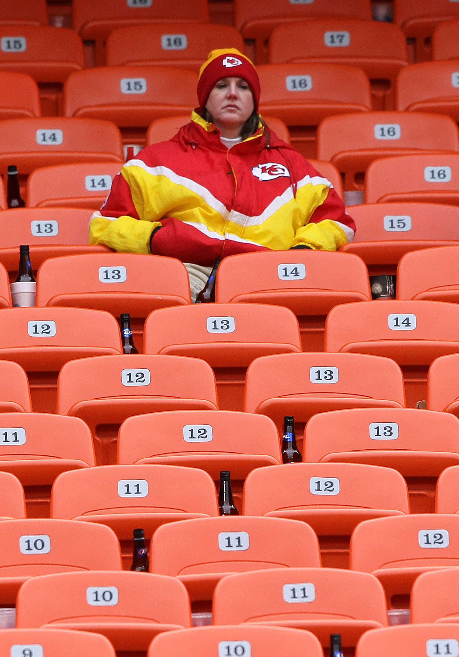 KANSAS CITY, MO - JANUARY 09:  A fan of the Kansas City Chiefs sits in the stands after the Baltimore Ravens defeated the Chiefs 30-7 in the 2011 AFC wild card playoff game at Arrowhead Stadium on January 9, 2011 in Kansas City, Missouri.  (Photo by Doug