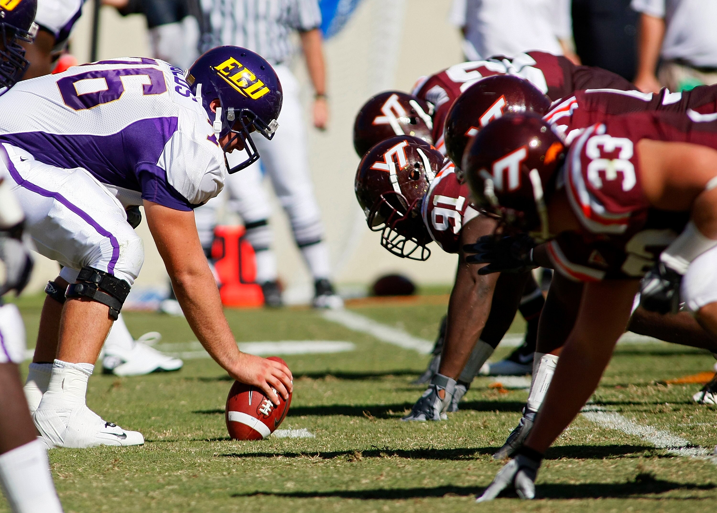 BLACKSBURG, VA - SEPTEMBER 18: East Carolina Pirates players line up against Virginia Tech Hokies players at Lane Stadium on September 18, 2010 in Blacksburg, Virginia.  (Photo by Geoff Burke/Getty Images)