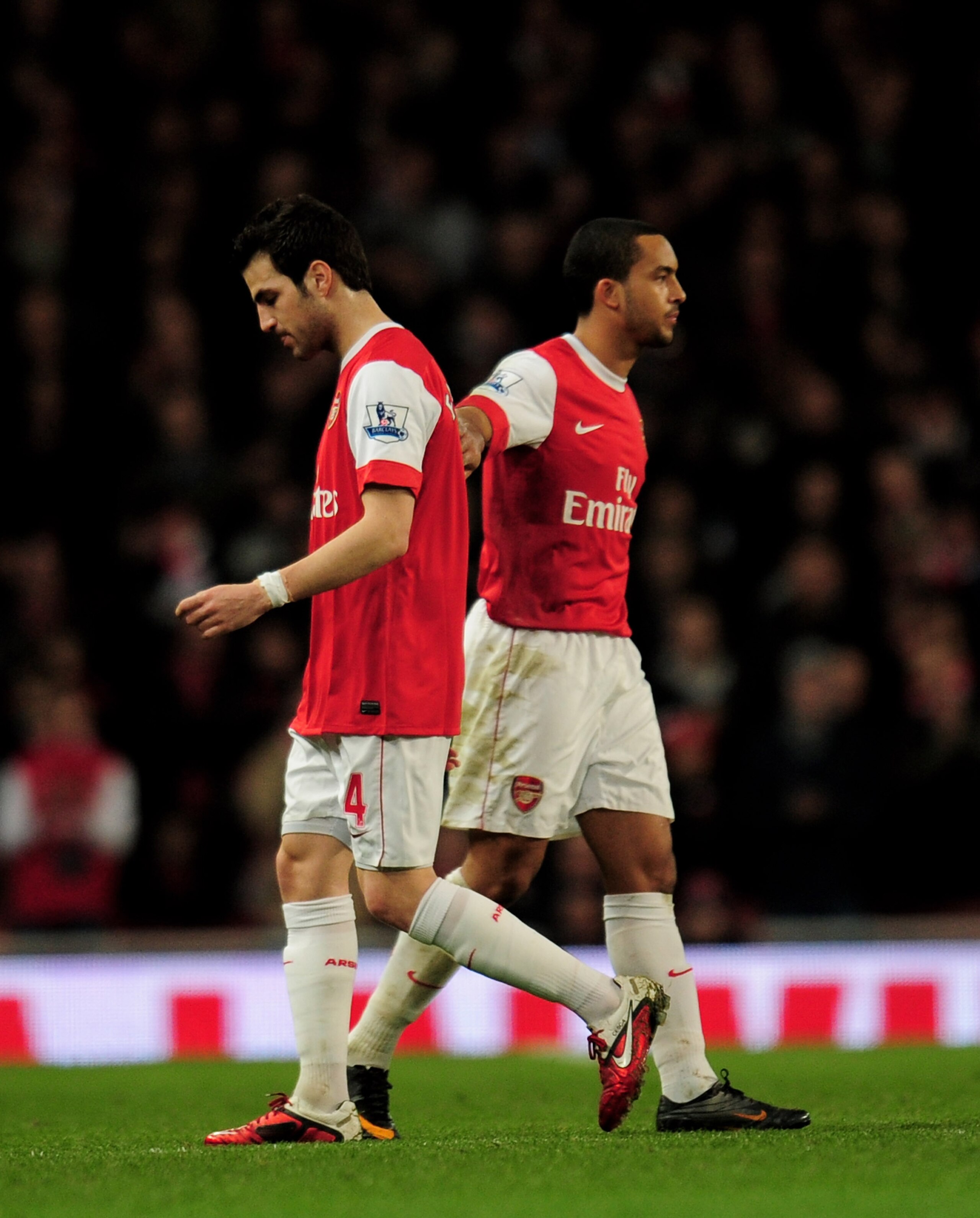 LONDON, ENGLAND - FEBRUARY 23:  Theo Walcott (R) of Arsenal pats teammate Cesc Fabregas as he is substituted during the Barclays Premier League match between Arsenal and Stoke City at the Emirates Stadium on February 23, 2011 in London, England.  (Photo b