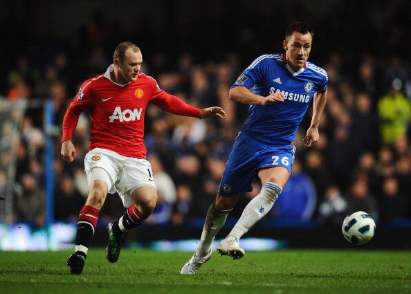 LONDON, ENGLAND - MARCH 01: John Terry of Chelsea is closed down by Wayne Rooney of Manchester United during the Barclays Premier League match between Chelsea and Manchester United at Stamford Bridge on March 1, 2011 in London, England.  (Photo by Clive M