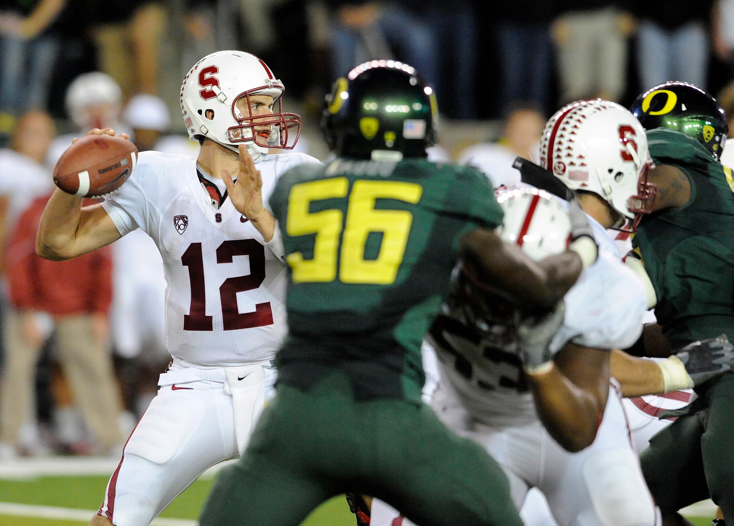 EUGENE, OR - OCTOBER 2: Quarterback Andrew Luck #12 of the Stanford Cardinal sets to throw a pass as linebacker Josh Kaddu #56 of the Oregon Ducks applies pressure in the third quarter of the game at Autzen Stadium on October 2, 2010 in Eugene, Oregon. Or