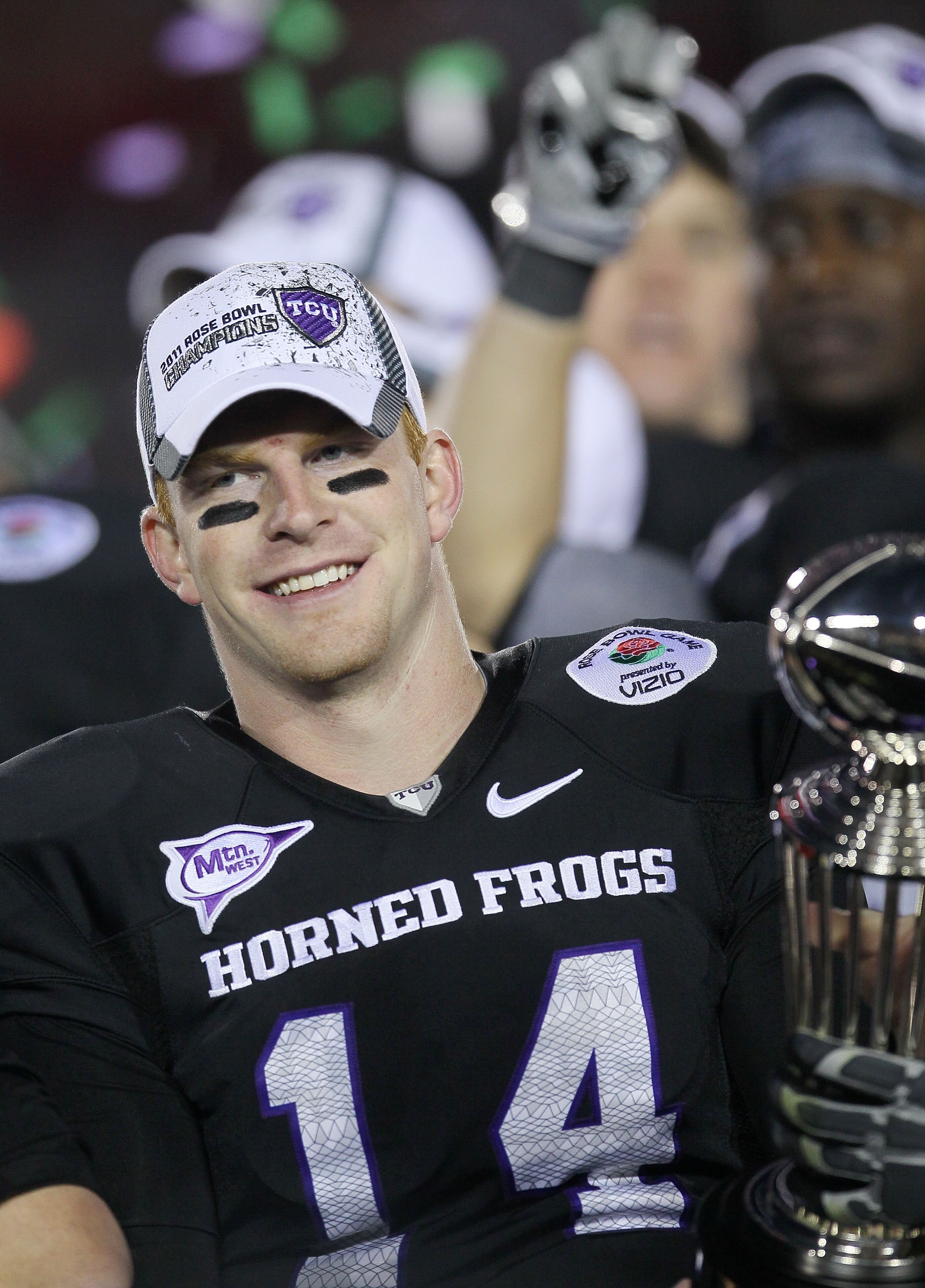PASADENA, CA - JANUARY 01:  Quarterback Andy Dalton #14 of the TCU Horned Frogs celebrates with the Rose Bowl Championship Trophy after defeating the Wisconsin Badgers 21-19 in the 97th Rose Bowl game on January 1, 2011 in Pasadena, California.  (Photo by