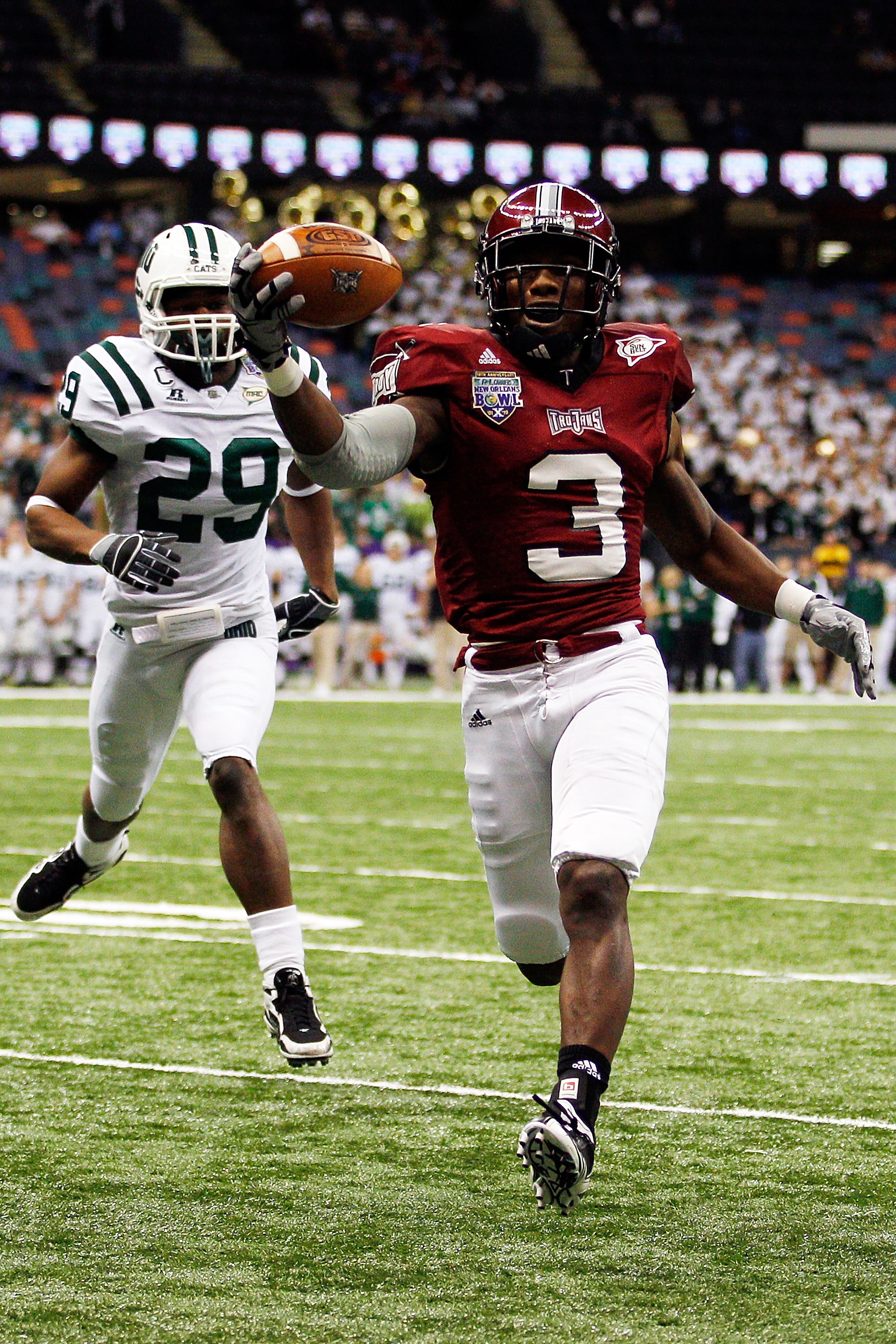 NEW ORLEANS, LA - DECEMBER 18:  Jerrel Jernigan #3 of the Troy University Trojans scores a touchdown over Donovan Fletcher #29 of the Ohio University Bobcats during the R&L Carriers New Orleans Bowl at the Louisiana Superdome on December 18, 2010 in New O
