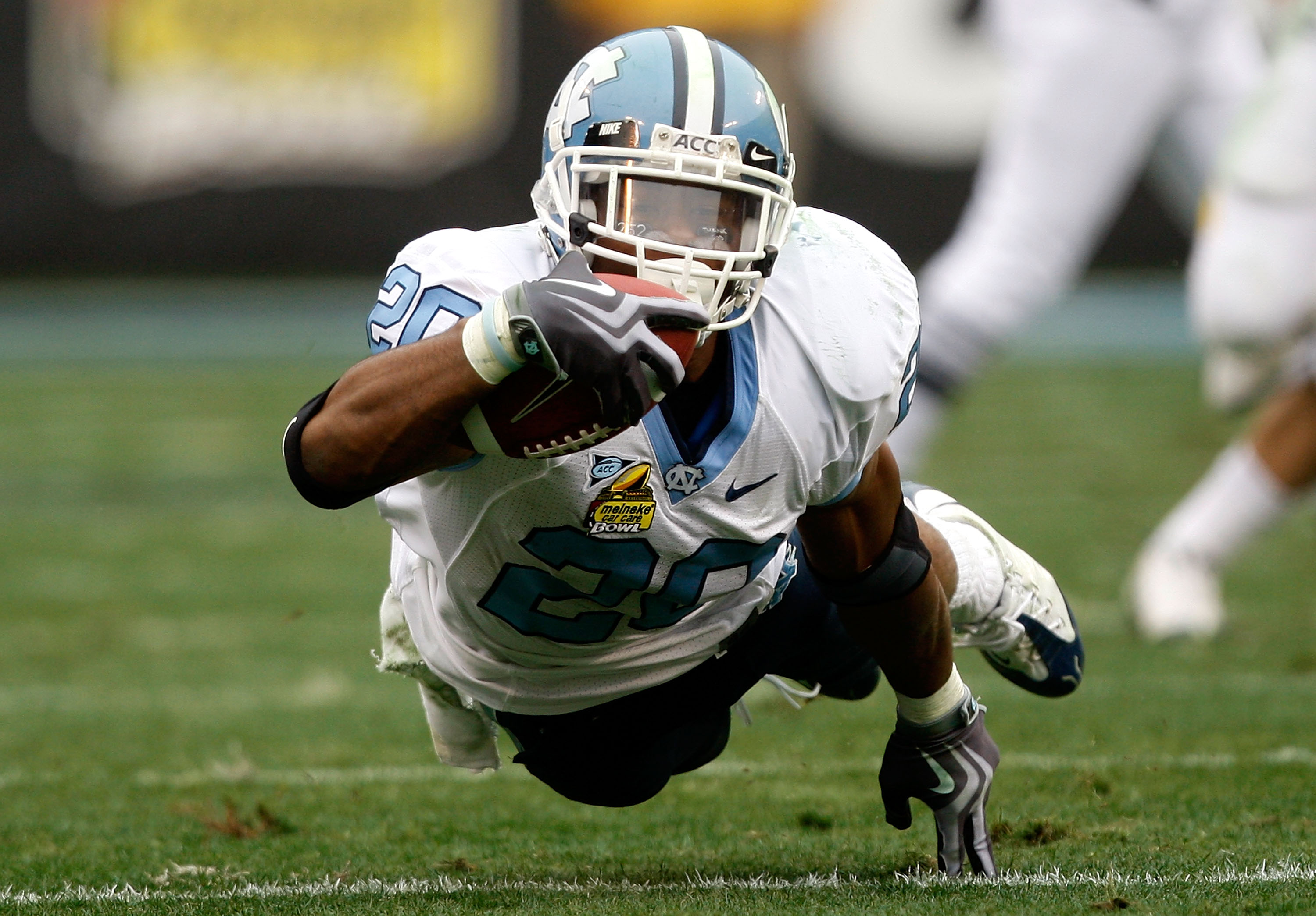 CHARLOTTE, NC - DECEMBER 27:  Shaun Draughn #20 of the North Carolina Tar Heels dives with the ball against the West Virginia Mountaineers during the Meineke Car Care Bowl on December 27, 2008 at Bank of America Stadium in Charlotte, North Carolina.  (Pho