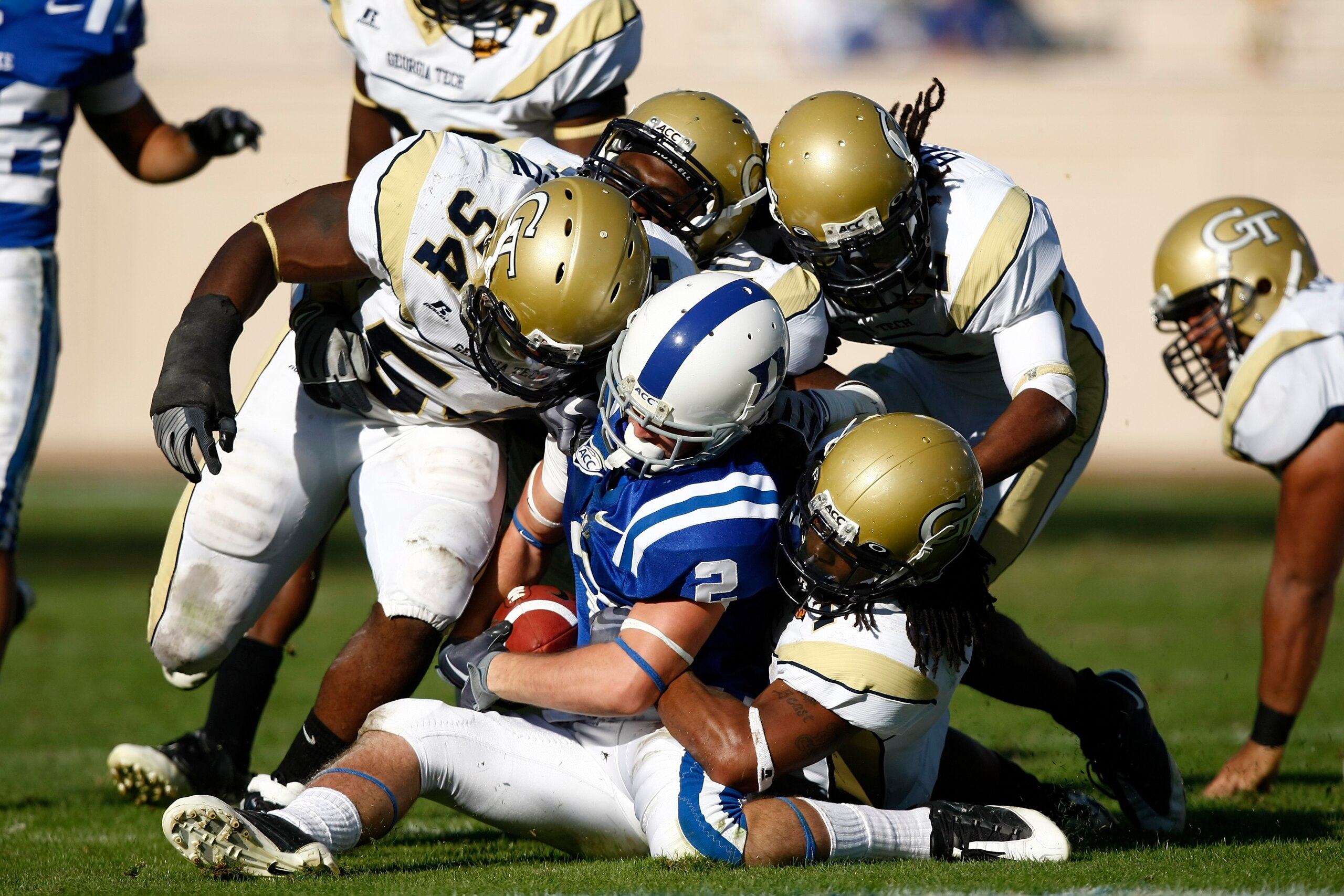 DURHAM, NC - NOVEMBER 14:  Morgan Burnett #1 and Sedric Griffin #54 of the Georgia Tech Yellow Jackets tackle Conner Vernon #2 of the Duke Blue Devils at Wallace Wade Stadium on November 14, 2009 in Durham, North Carolina. (Photo by Joe Robbins/Getty Imag