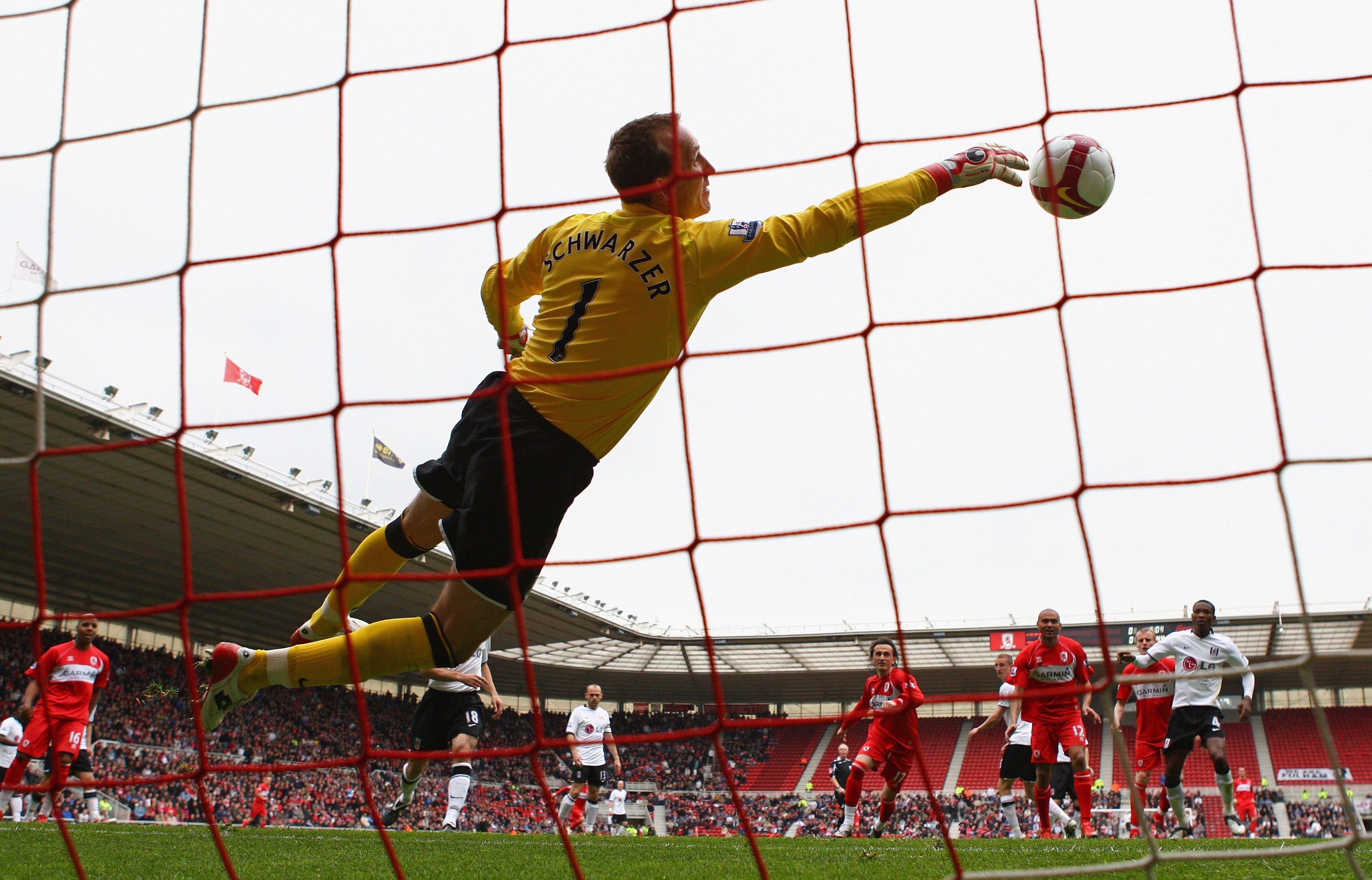 MIDDLESBROUGH, ENGLAND - APRIL 18:  Mark Schwarzer of Fulham makes a diving save against his former club during the Barclays Premier League match between Middlesbrough and Fulham at the Riverside Stadium on April 18, 2009 in Middlesbrough, England.  (Phot