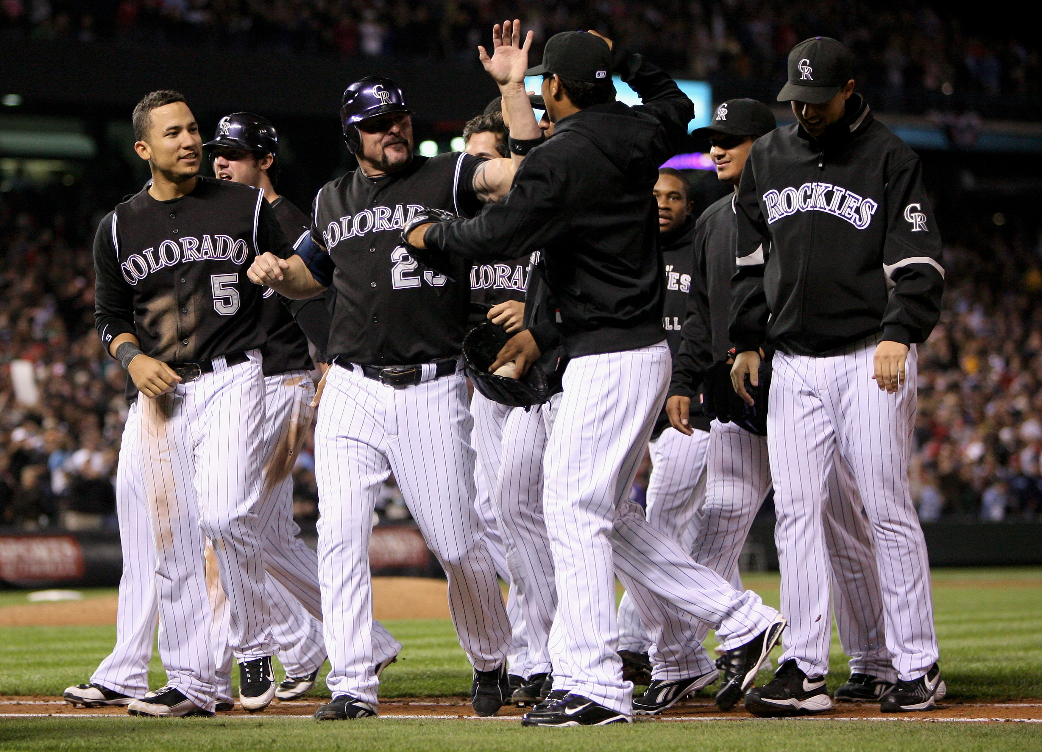 DENVER - SEPTEMBER 25:  Jason Giambi #23 of the Colorado Rockies celebrates with his teammates after defeating the St. Louis Cardinals at Coors Field on September 25, 2009 in Denver, Colorado. Giambi had a pinch hit single in the ninth inning as the Rocki
