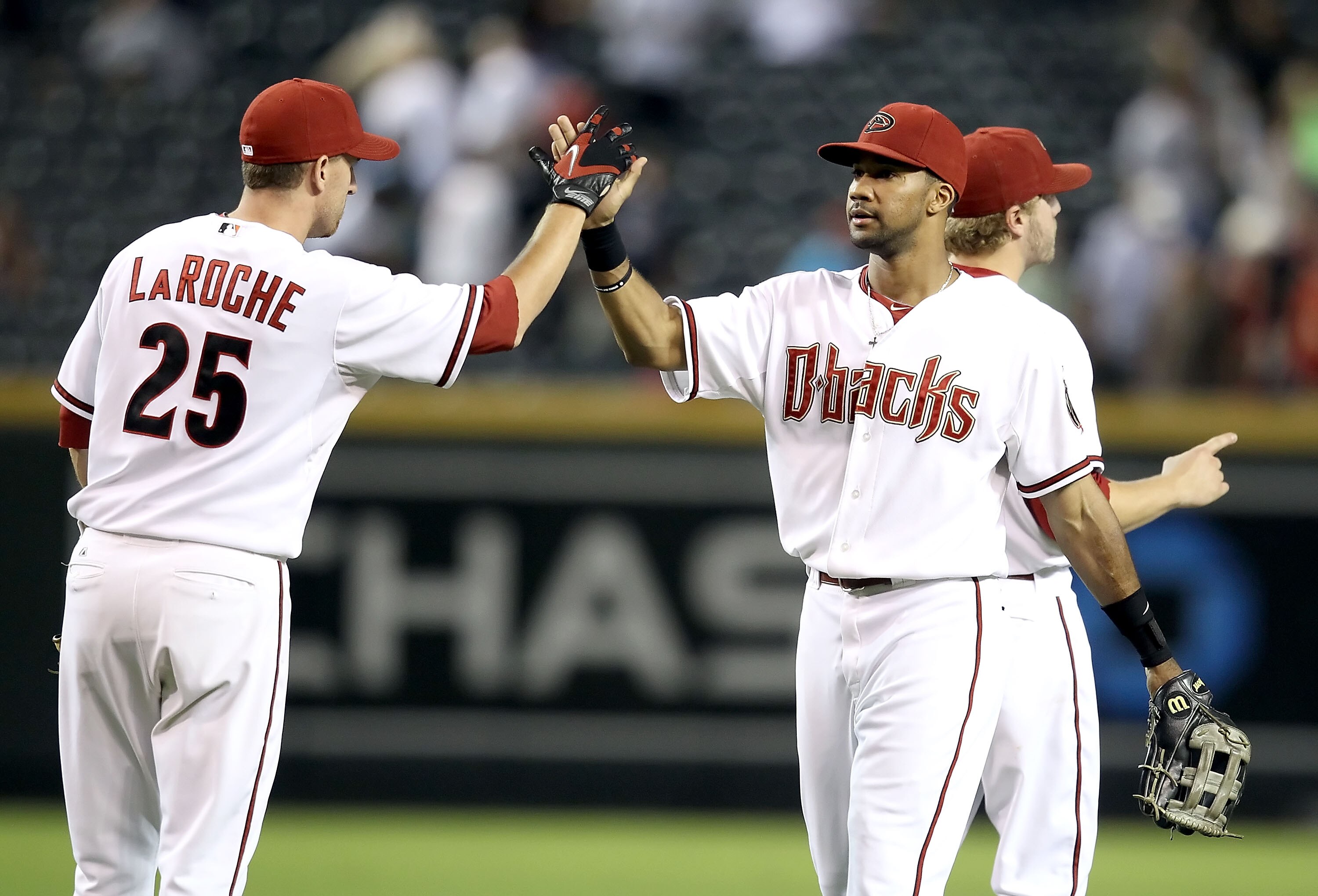 PHOENIX - SEPTEMBER 21:  Chris Young #24 of the Arizona Diamondbacks celebrates with teammate Adam LaRoche #25 after defeating the Colorado Rockies during the Major League Baseball game at Chase Field on September 21, 2010 in Phoenix, Arizona.  (Photo by