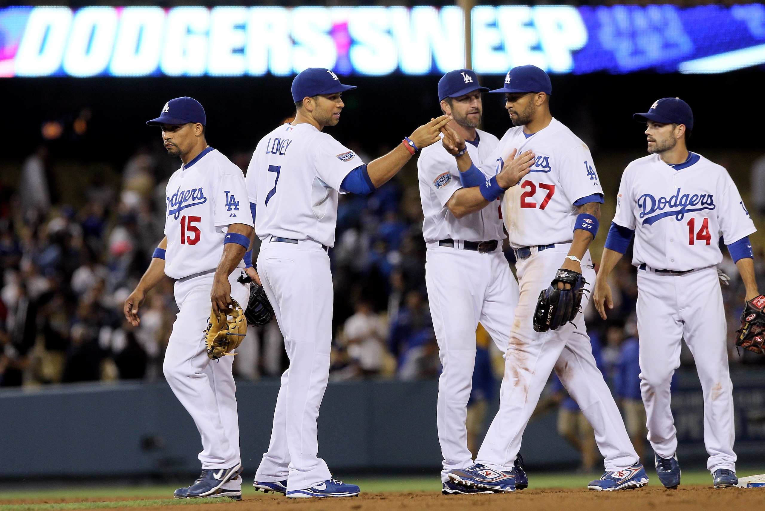 LOS ANGELES, CA - JUNE 09:  (L-R) Rafael Furcal #15, James Loney #7, Casey Blake #23, Matt Kemp #27 and Jamey Carroll #14 of the Los Angeles Dodgers celebrate their teams victory and three-game sweep of the St. Louis Cardinals at Dodger Stadium on June 9,