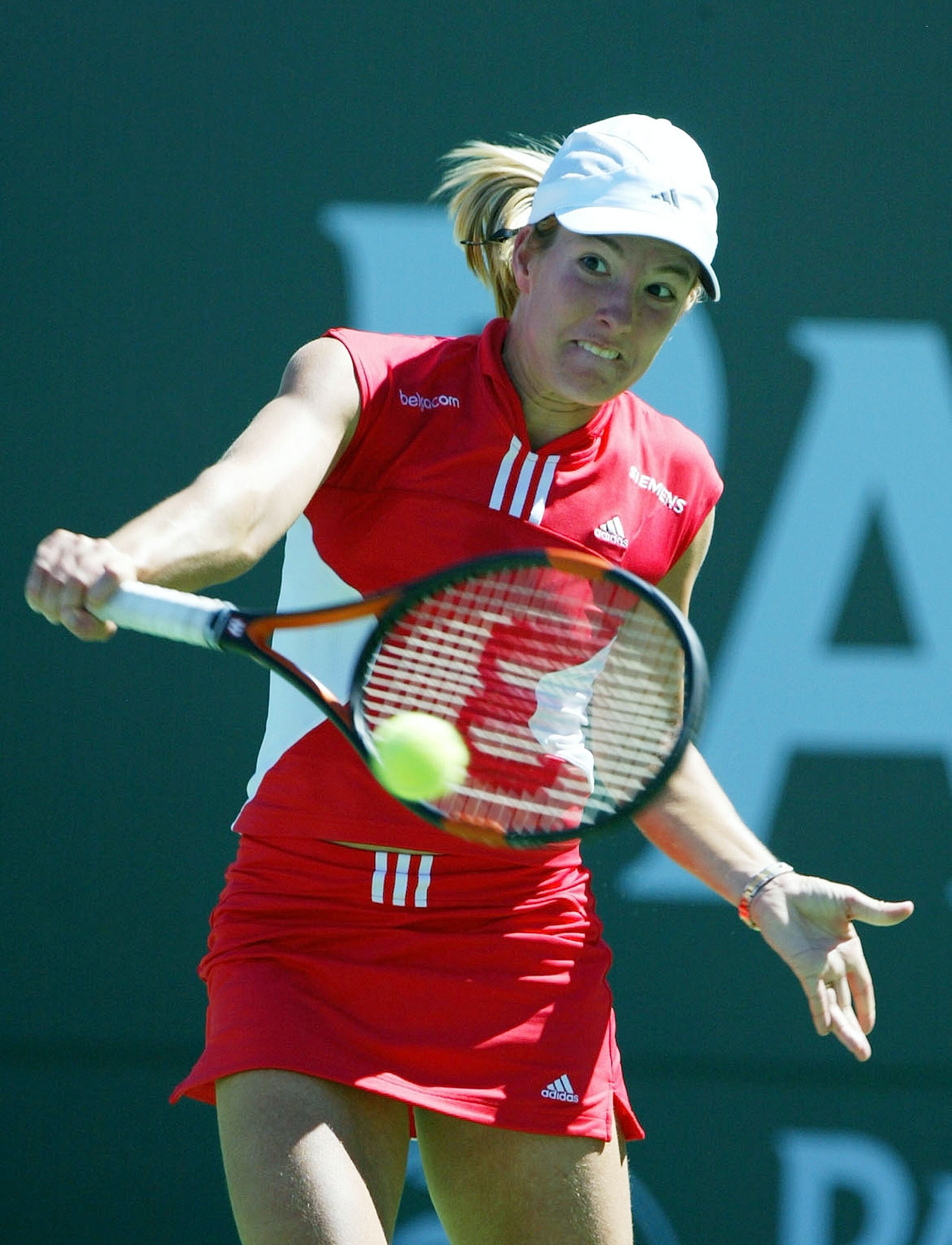 INDIAN WELLS, CA - MARCH 21: Justine Henin-Hardenne of Belgium returns the ball before defeating Lindsay Davenport of the U.S. during the Women's Final match by a score of 6-1, 6-4 at the Pacific Life Open on March 21, 2004 at the Indian Wells Tennis Gar INDIAN WELLS, CA - MARCH 21: Justine Henin-Hardenne of Belgium returns the ball before defeating Lindsay Davenport of the U.S. during the Women's Final match by a score of 6-1, 6-4 at the Pacific Life Open on March 21, 2004 at the Indian Wells Tennis Gar