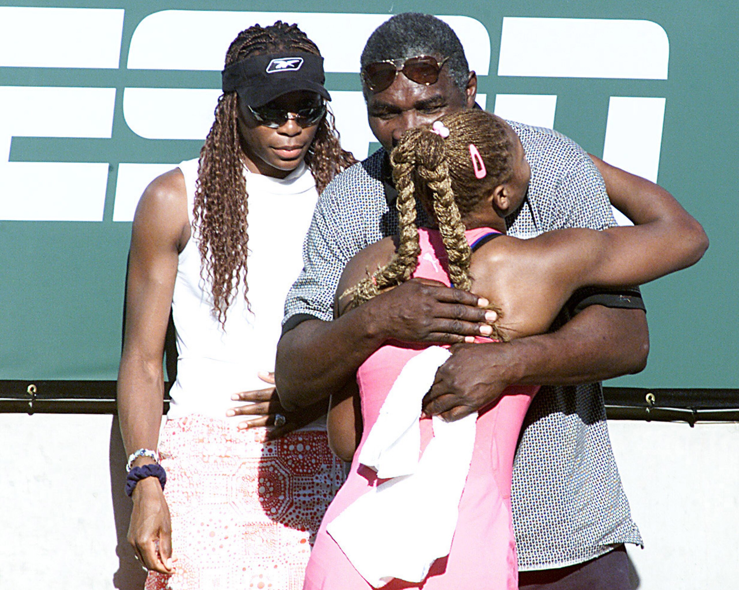17 Mar 2001: Serena Williams of the USA hugs her father Richard as her sister Venus waits in the back after her victory over Kim Clijsters of Belgium during the final of the Tennis Masters Series at Indian Wells, California. <DIGITAL IMAGE> Mandatory Cre 17 Mar 2001: Serena Williams of the USA hugs her father Richard as her sister Venus waits in the back after her victory over Kim Clijsters of Belgium during the final of the Tennis Masters Series at Indian Wells, California. <DIGITAL IMAGE> Mandatory Cre